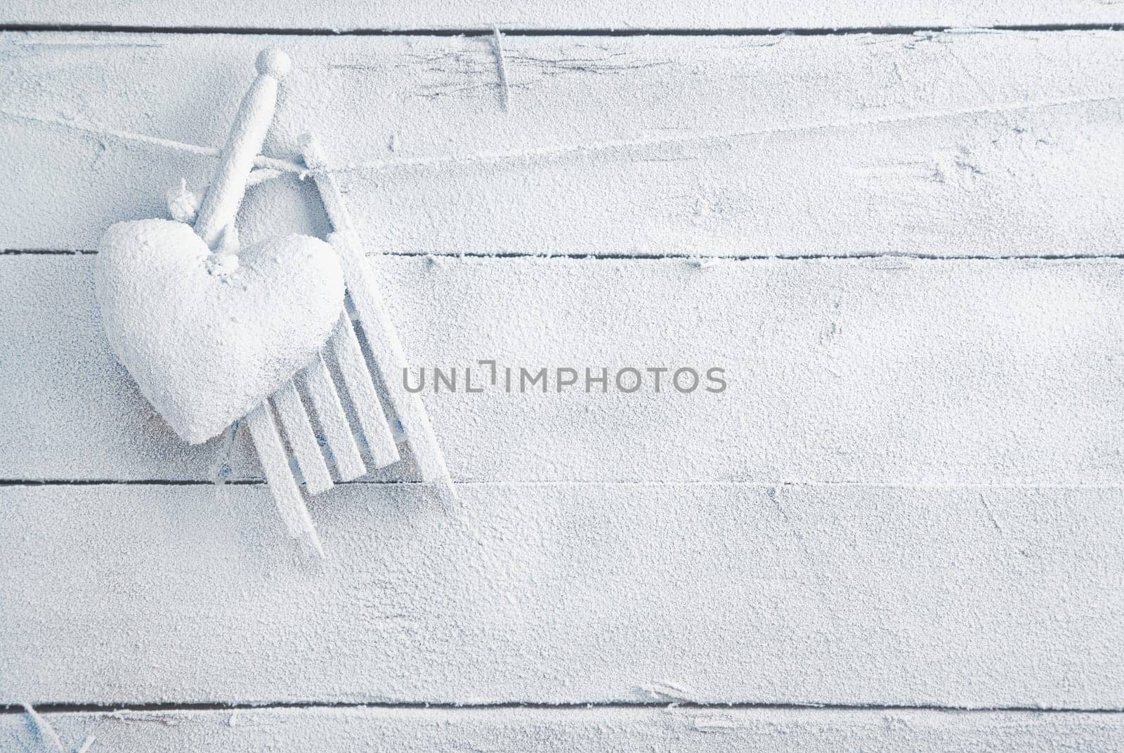 Romantic checked snowy needlework heart for Valentines hanging on snow white boards with copyspace