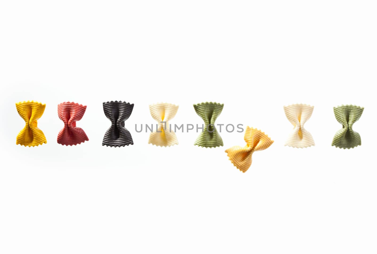 A row of noodles with different colors isolated on white background