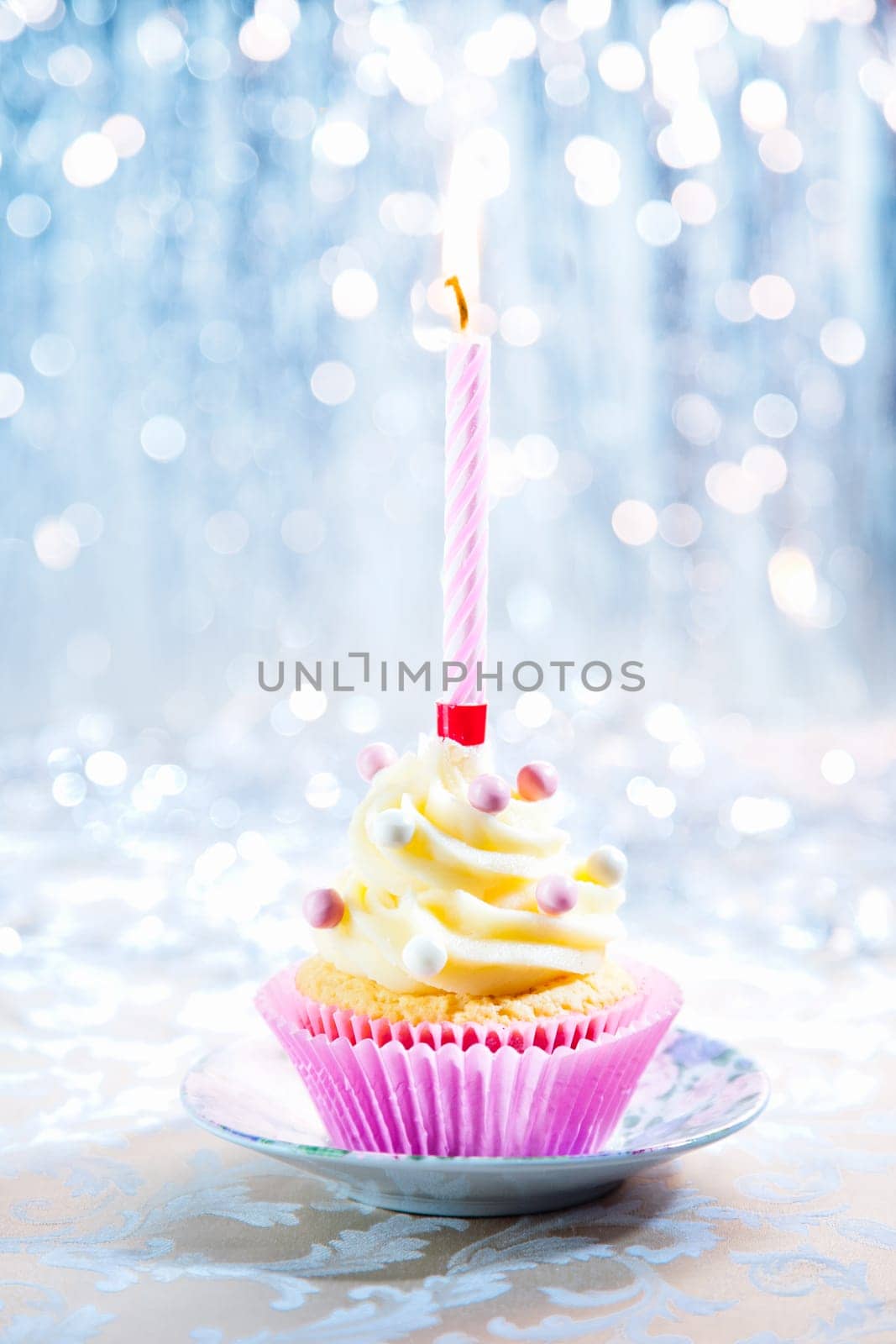 Happy Birthday cupcake with a candle on a boketh background