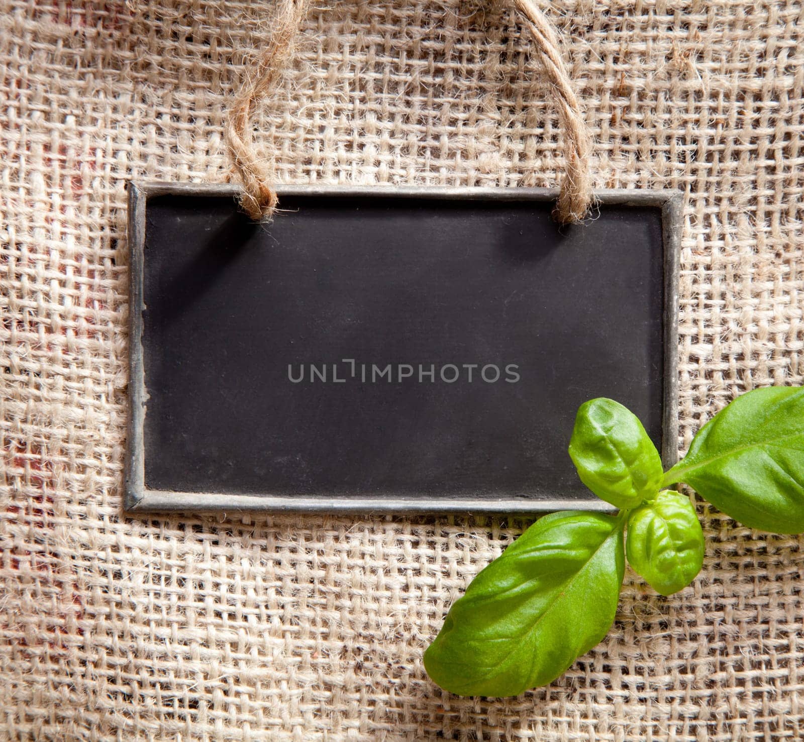 a chalkboard on a textile coffee bag with basil