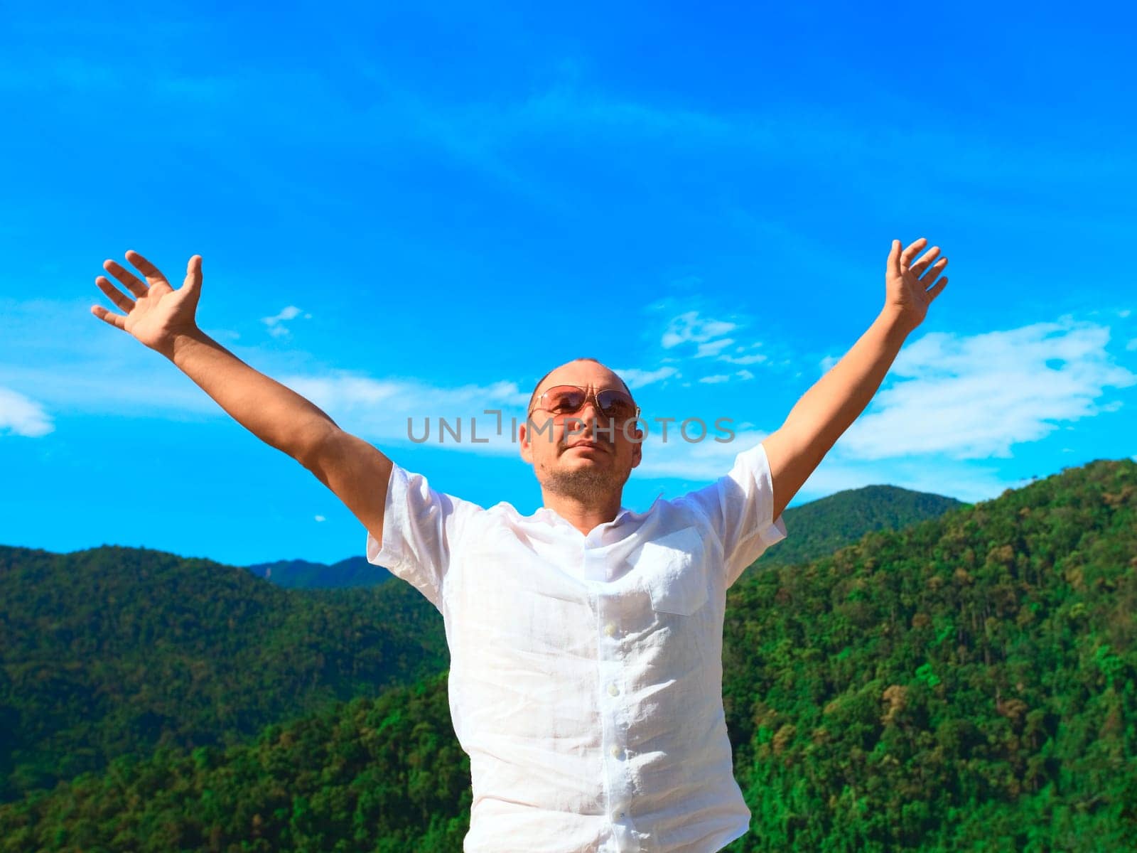 Man with opened hands on mountain background