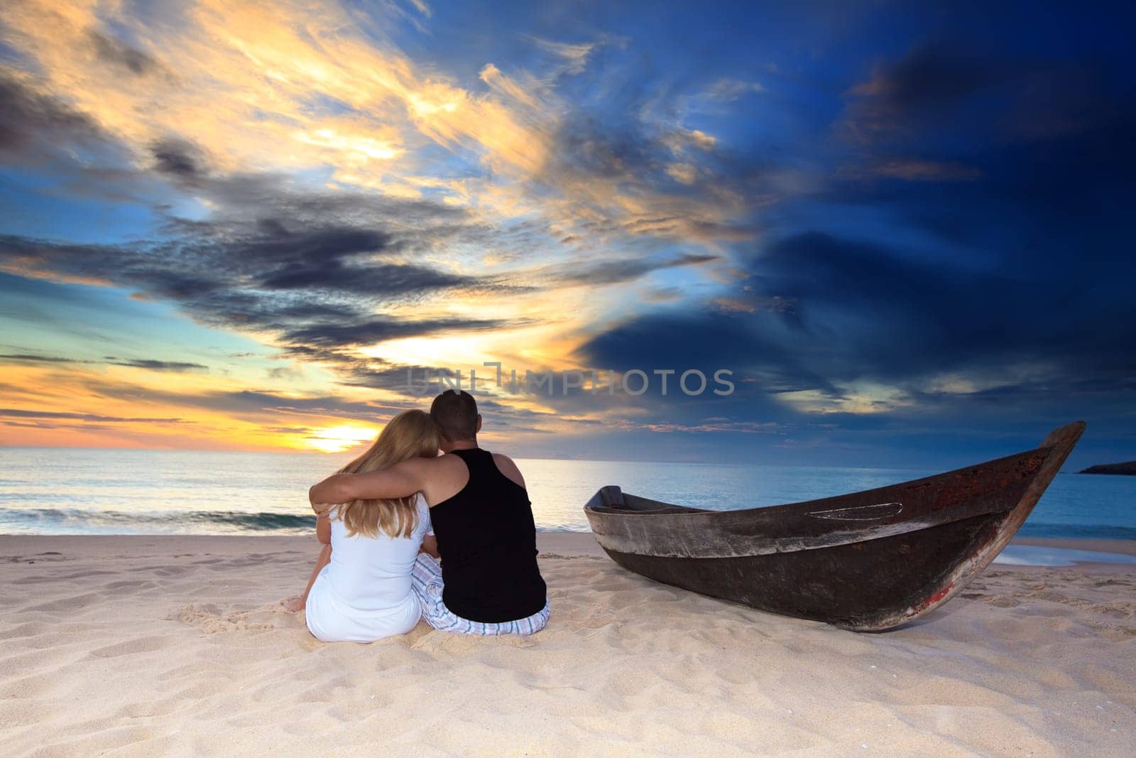 Romantic couple at uninhabited island at sunset time