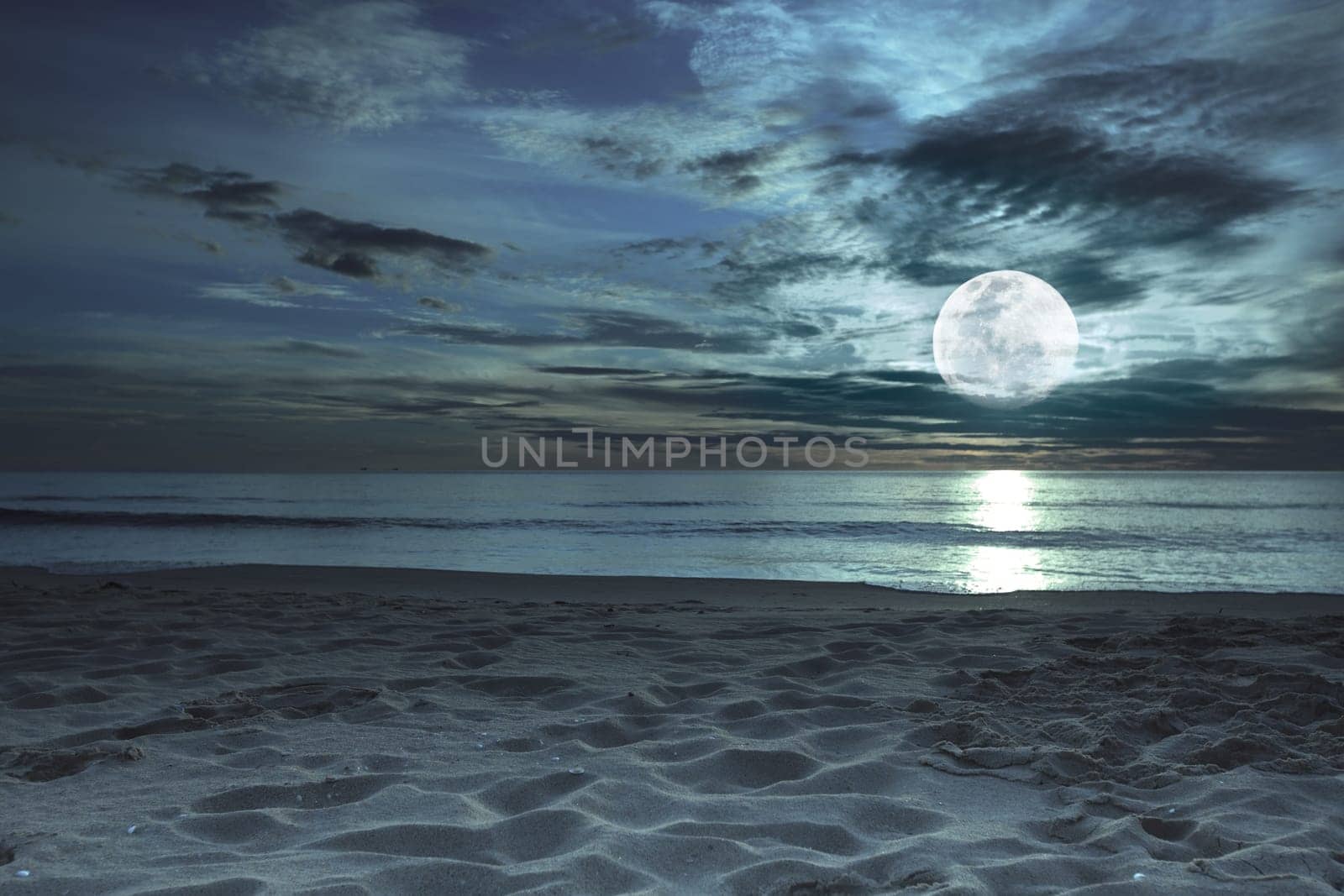Beautiful beach at twilight time with moon in the sky