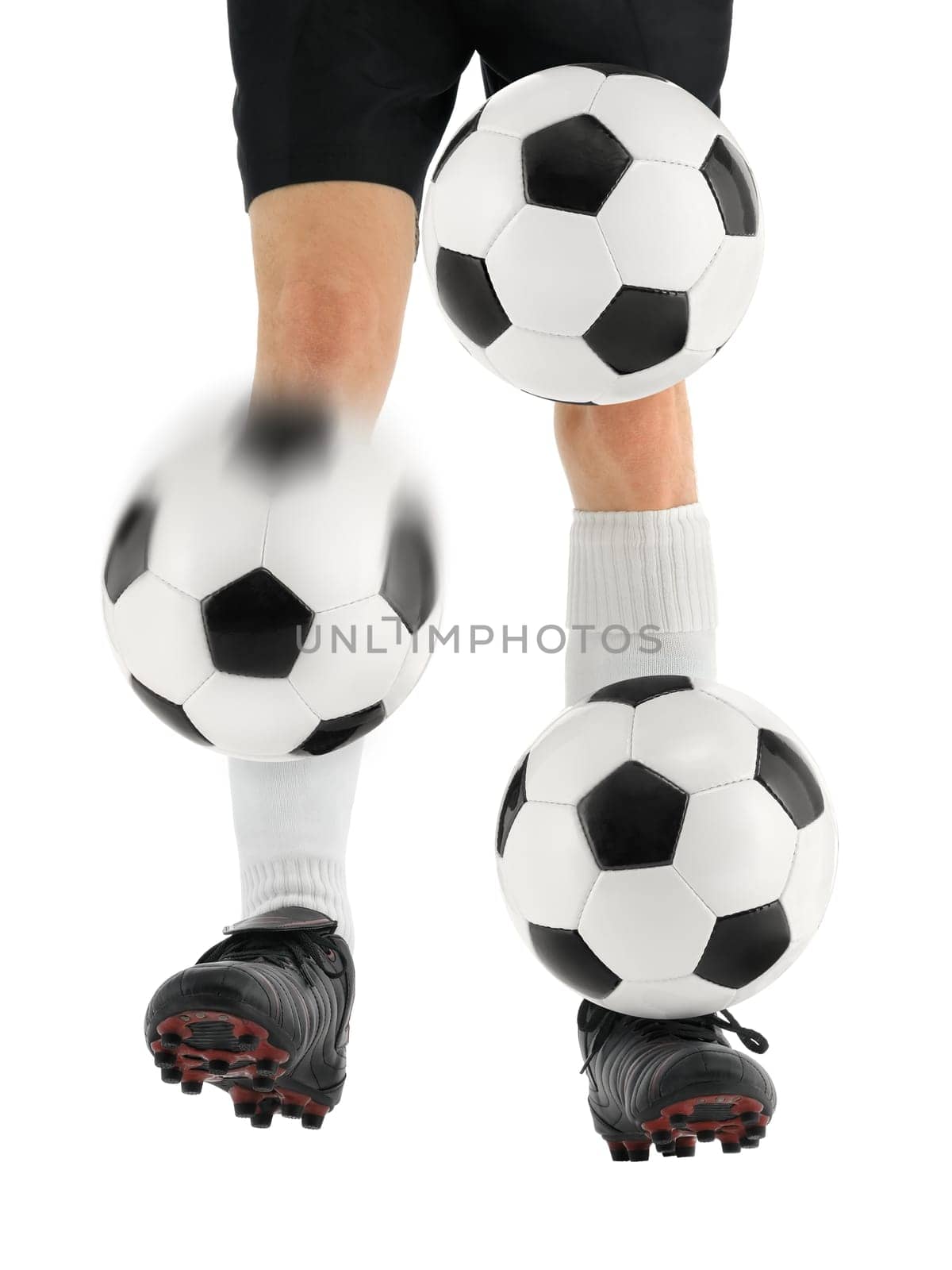 Skillful footballer juggles three footballs with his feet