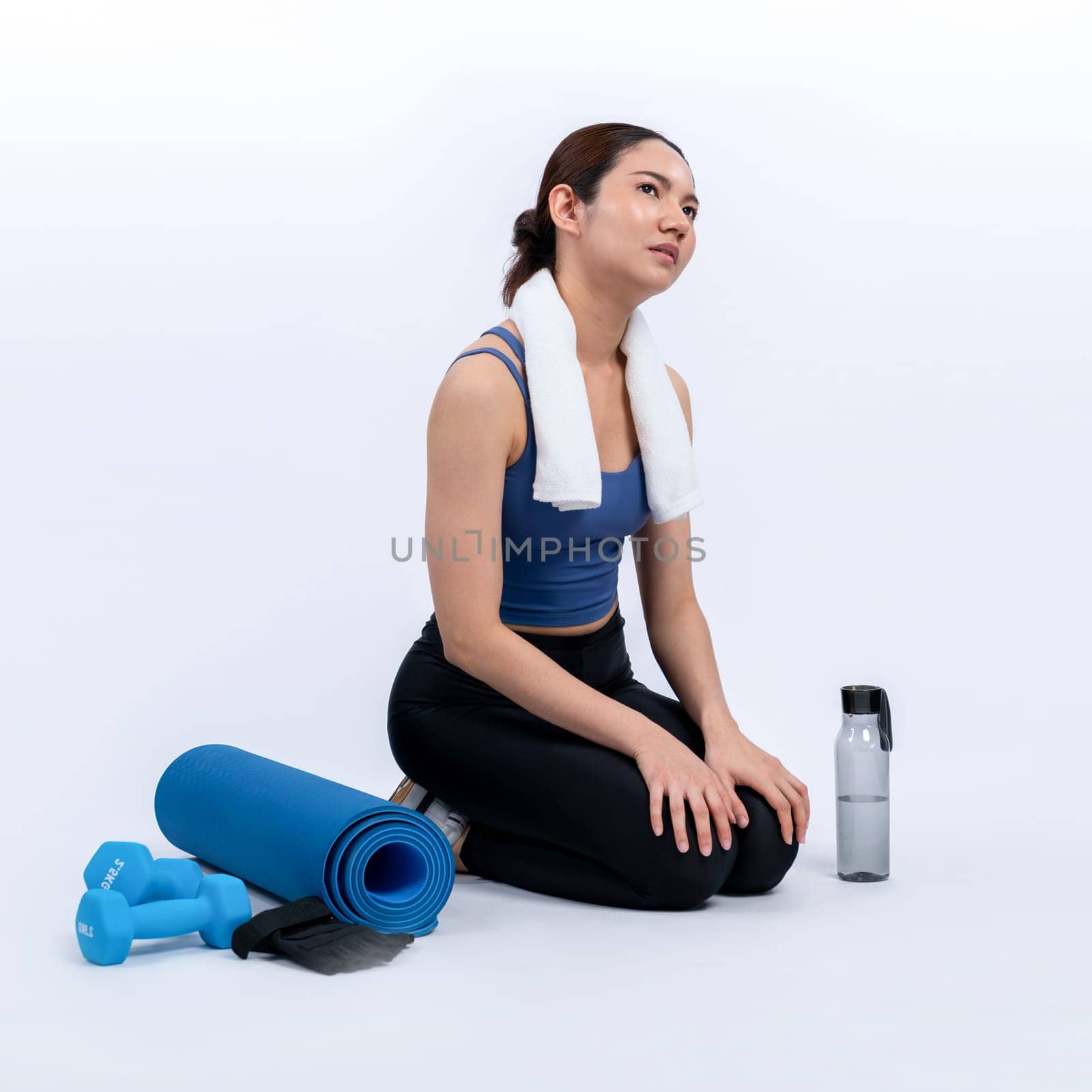 Athletic and sporty asian woman resting after intensive cardio workout training. Healthy exercising and fit body care lifestyle pursuit in studio shot isolated background. Vigorous