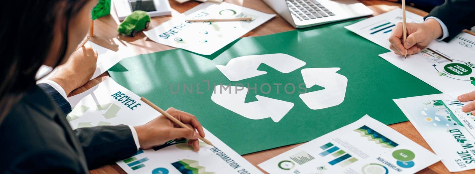 Group of business people planning and discussing on recycle reduce reuse policy symbol in office meeting room. Green business company with eco-friendly waste management regulation concept.Trailblazing