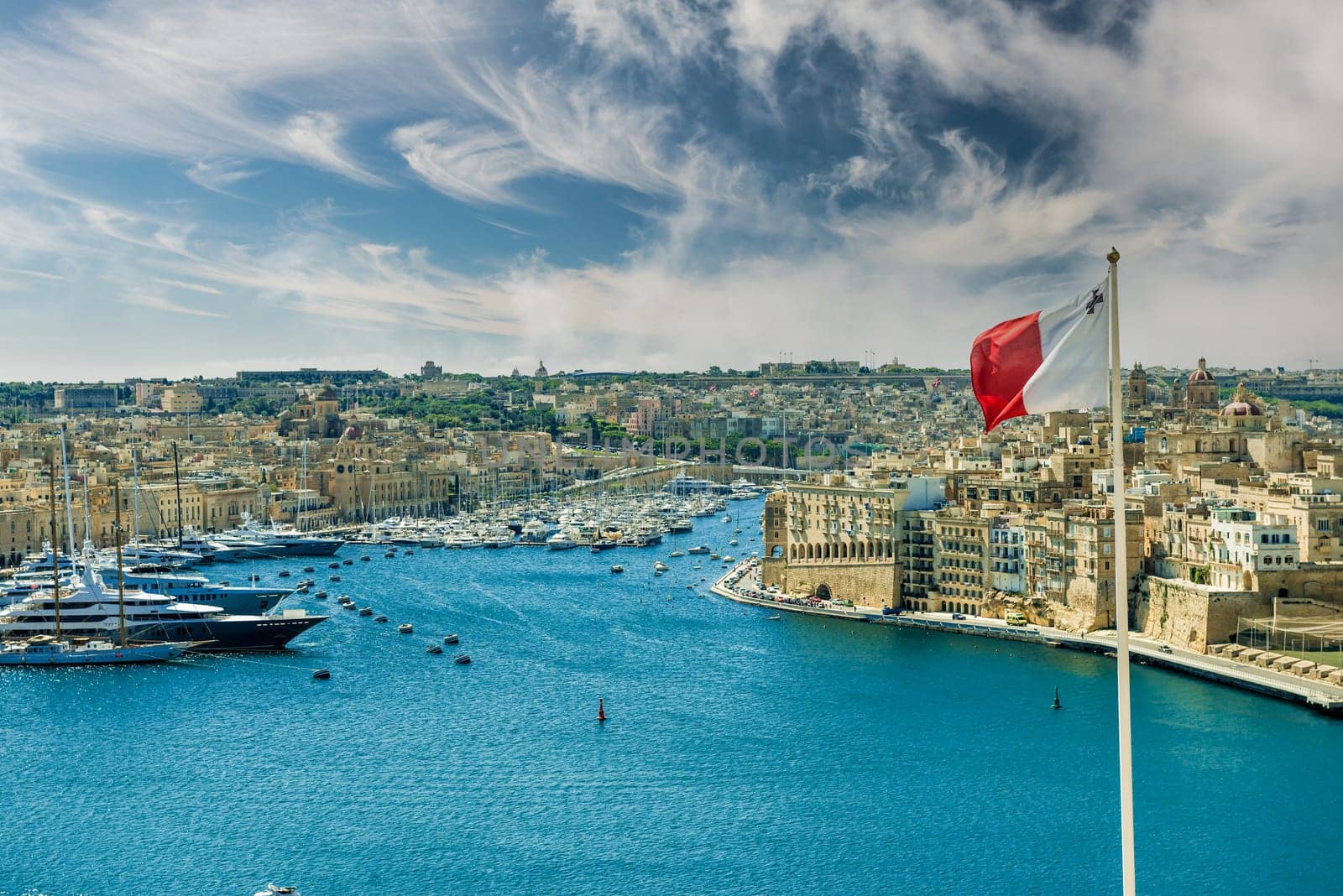panoramic view on Valletta with the flag of Malta in the foreground
