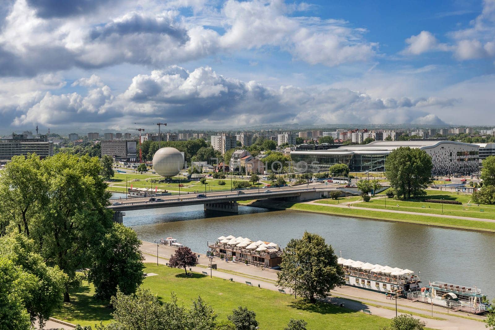 POLAND, KRAKOW- JULY 03: Urban areas modern bridge and the river, gardens and alleys to wall in Krakow Poland on July 03, 2015