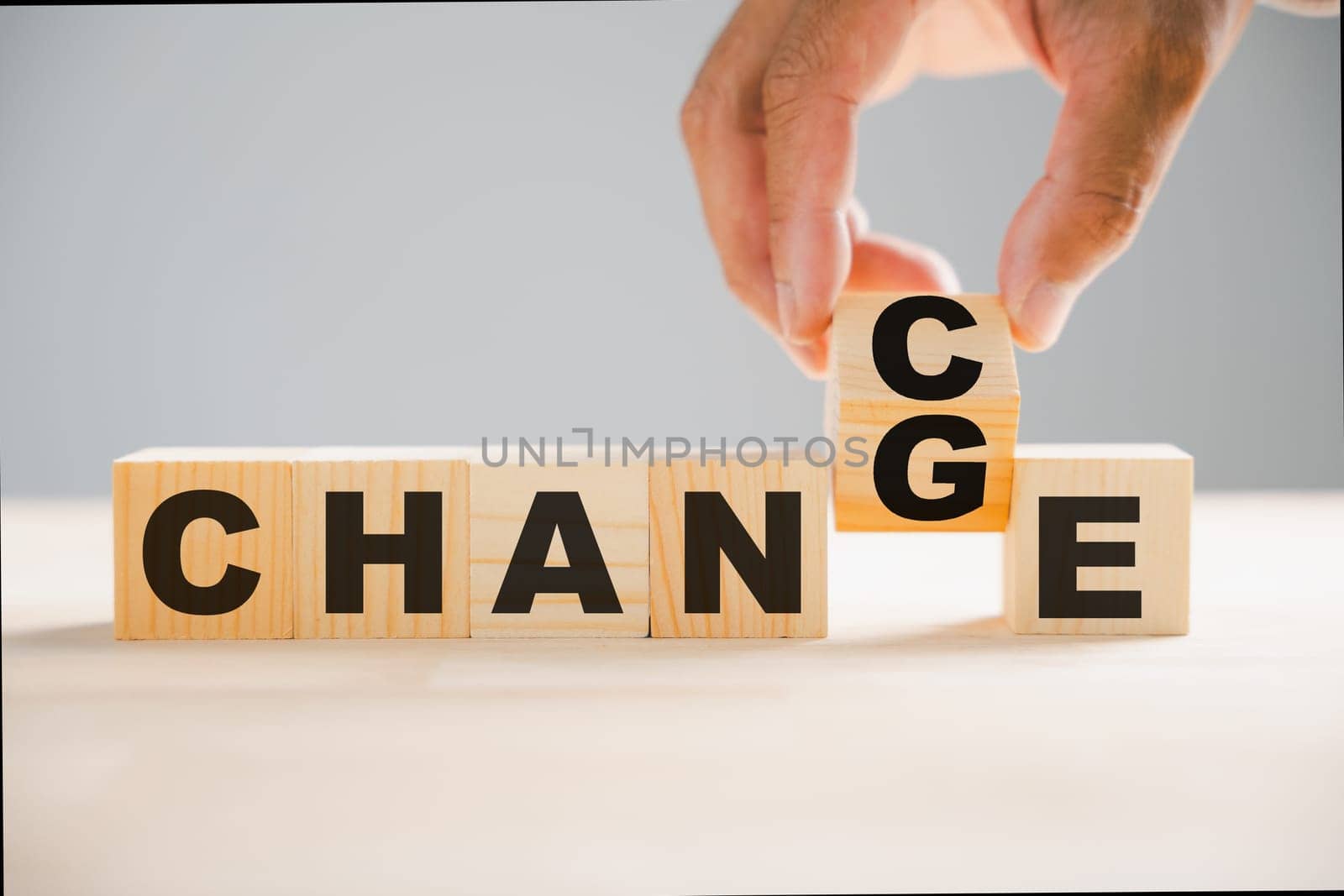 From CHANGE to CHANCE, wood block flipped by businessman hand. Success, strategy, positive thinking concepts portrayed. Vintage table setting adds charm. Change is represented.