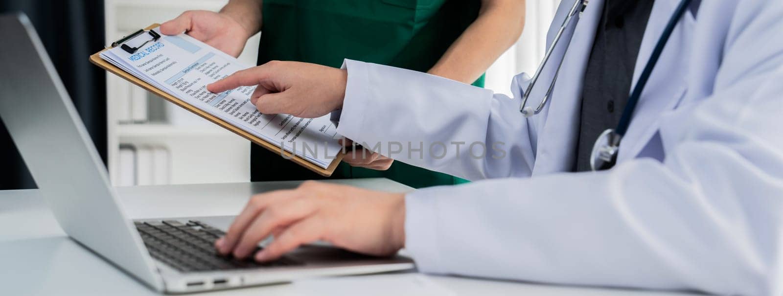 Professional various team of medical working and planning medical treatment at hospital table together. Teamwork lead to successful illness and sickness treatment. Panorama Rigid