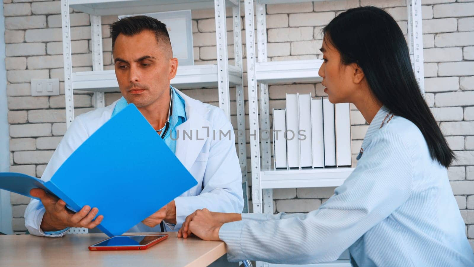 Doctor in professional uniform examining patient at hospital or medical clinic. Health care , medical and doctor staff service concept. Jivy