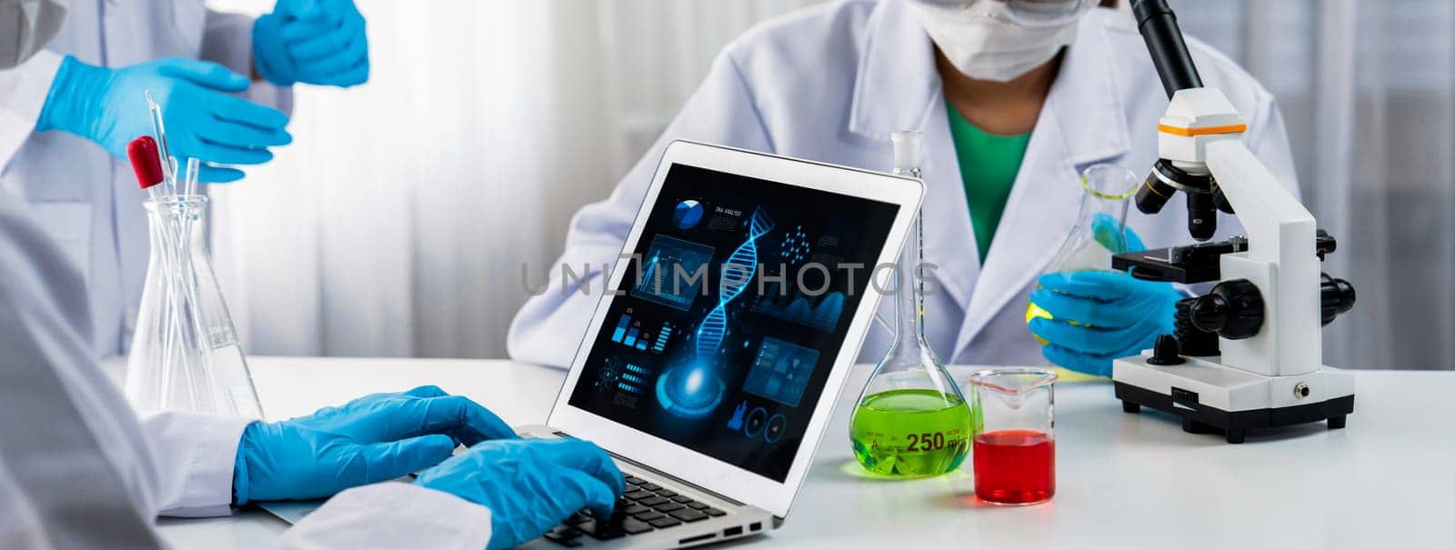 Laboratory research team advance healthcare with scientific expertise, laboratory equipment, and innovative medical biotechnology software, researching new medicines and developing cure.Panorama Rigid