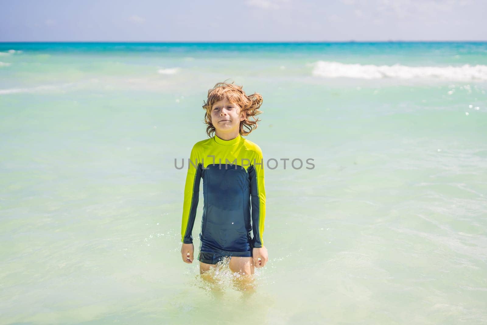 A carefree boy explores the wonders of the beach, with the sun-kissed shoreline as his playground, embodying the spirit of childhood adventure.