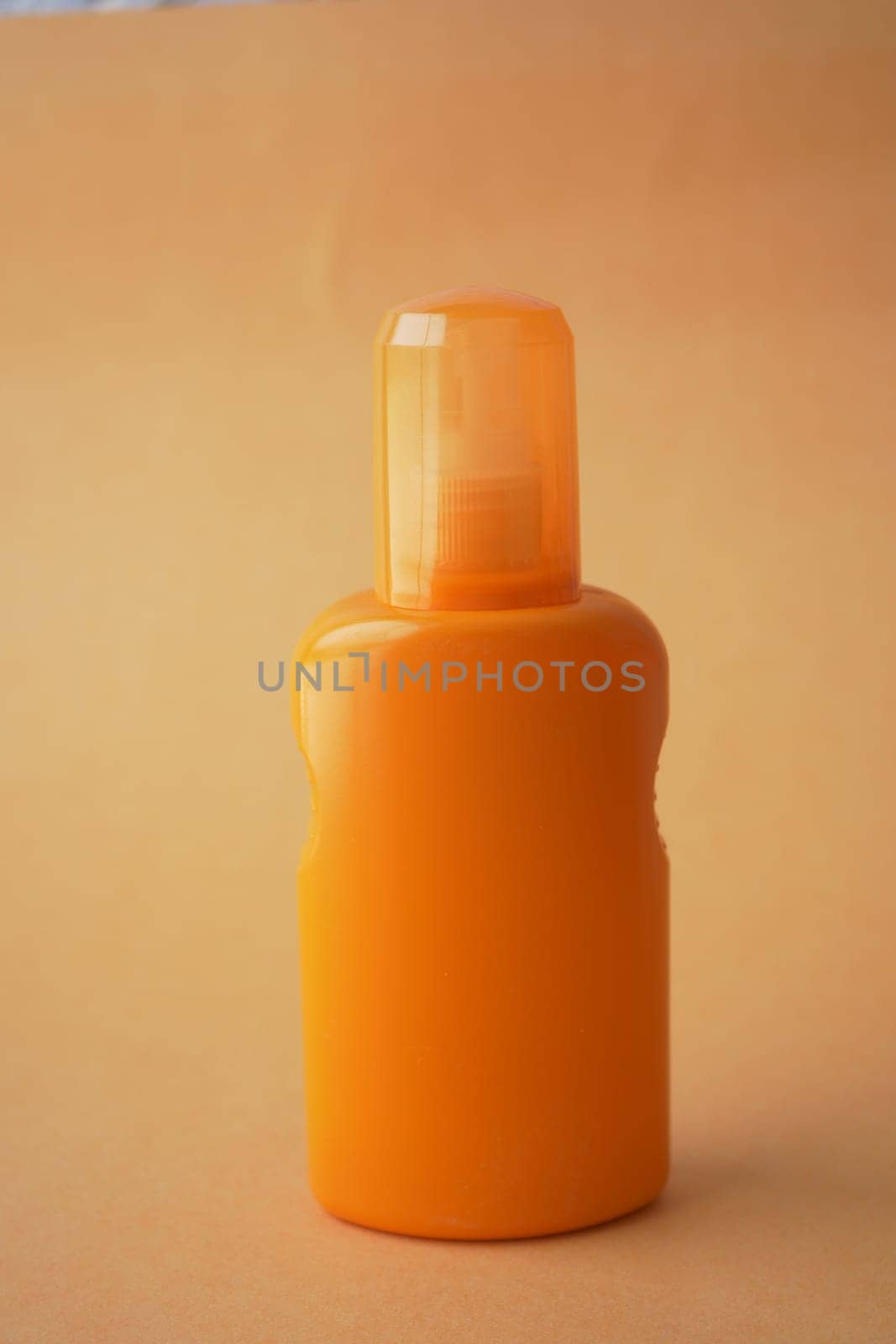 Close up of sunscreen cream ion orange color background by towfiq007