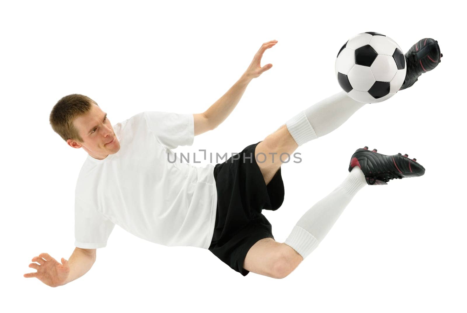 Isolated studio shot of a soccer player taking a overhead kick