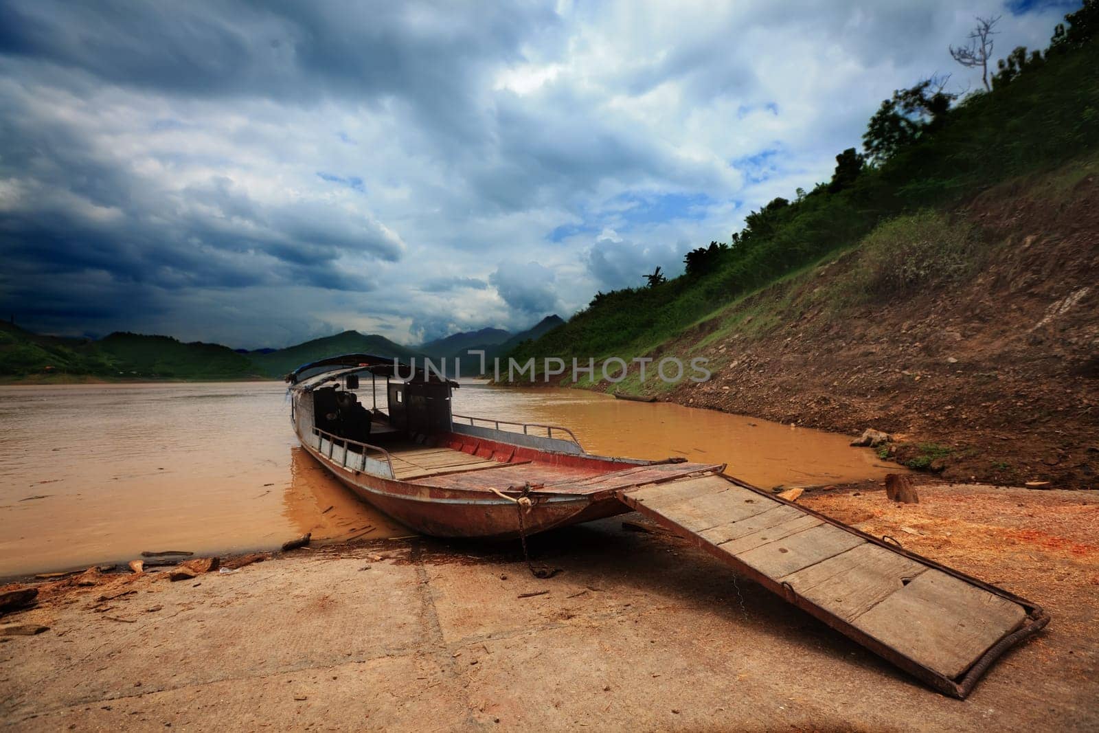 Old ferry on the river with dramatic sky