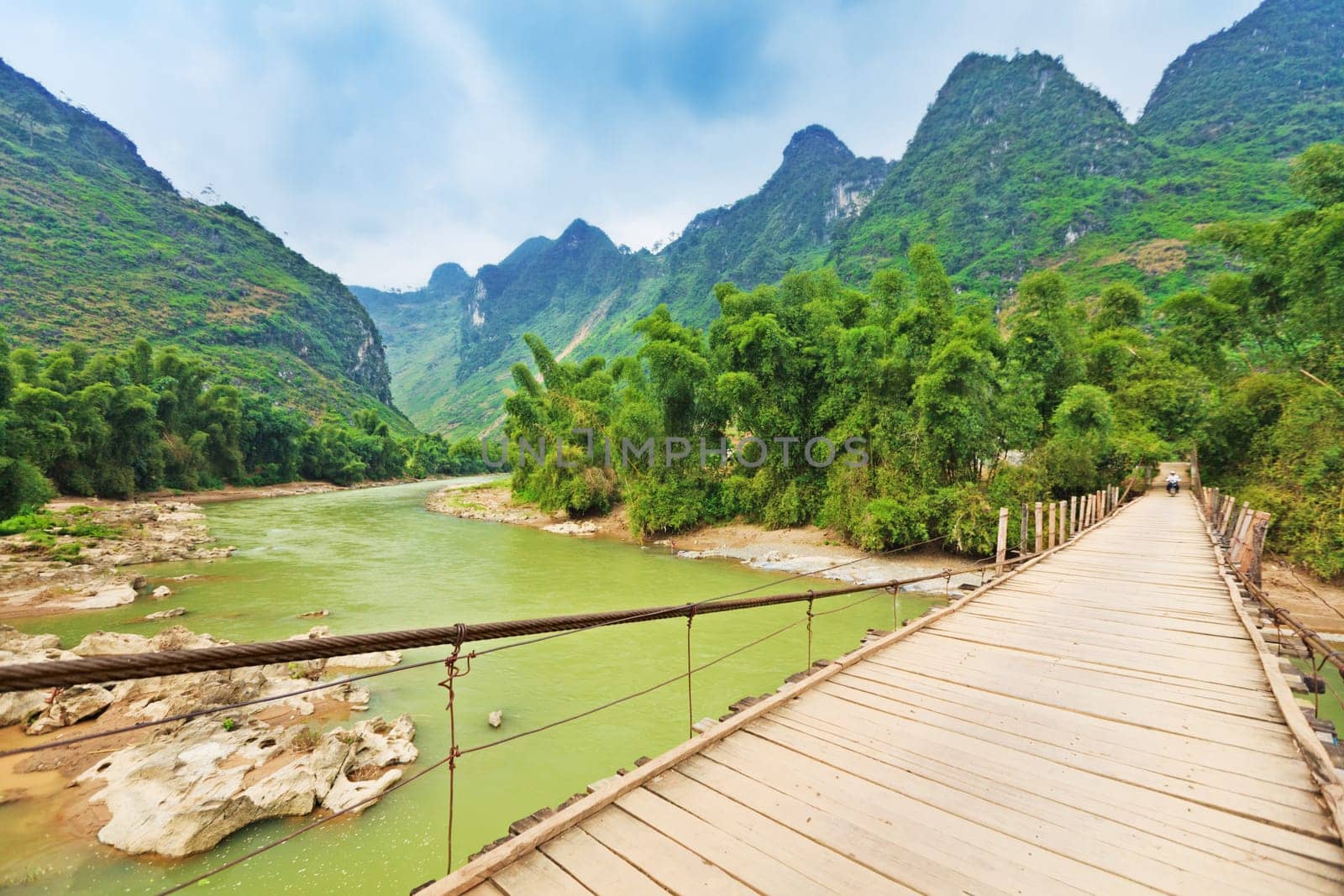 Wooden bridge over mountain river. Northern Vietnam