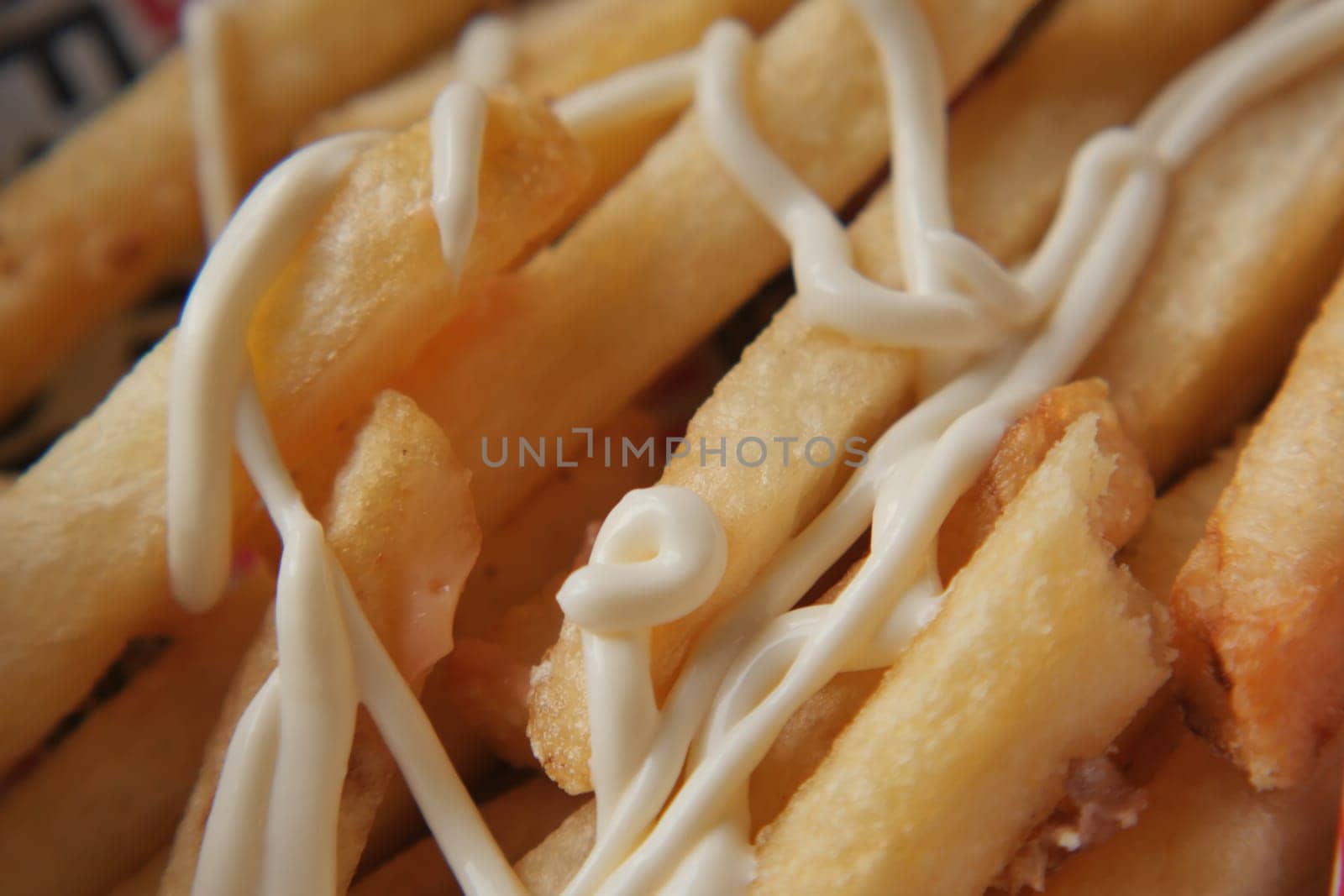 Crispy fries served with a generous drizzle of creamy sauce elevate flavors.