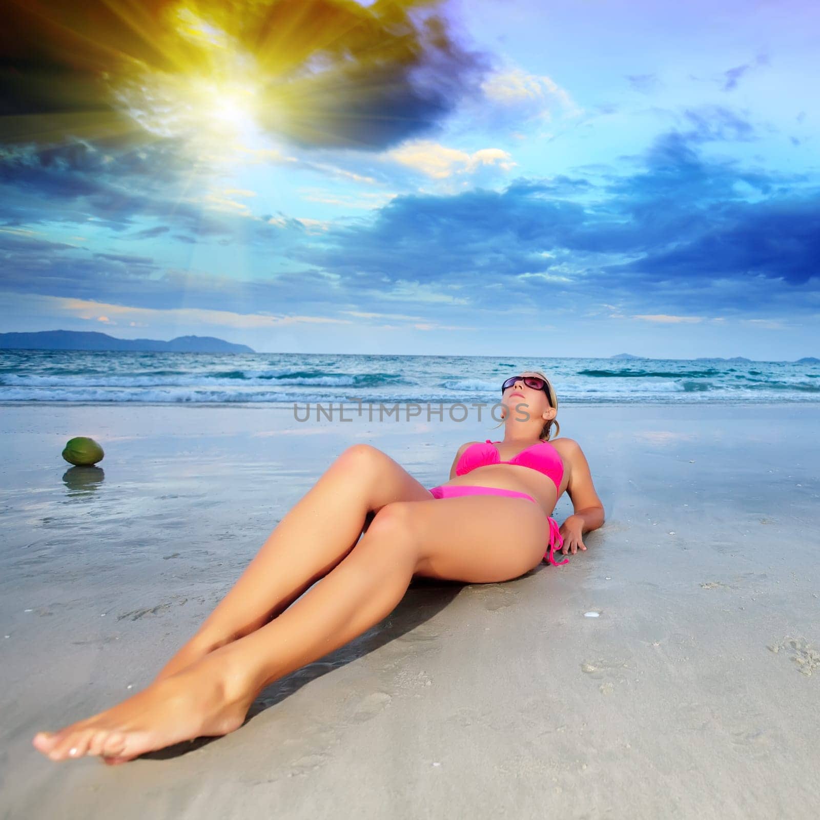 Young woman in bikini near the ocean