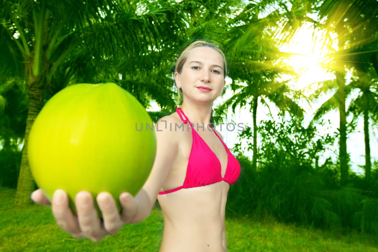 Beautiful woman holding coconut in her hands