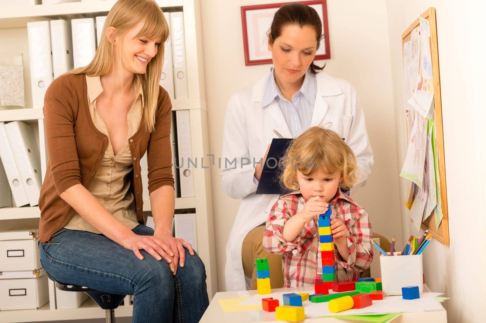 Visit at pediatrician little child girl play at medical office