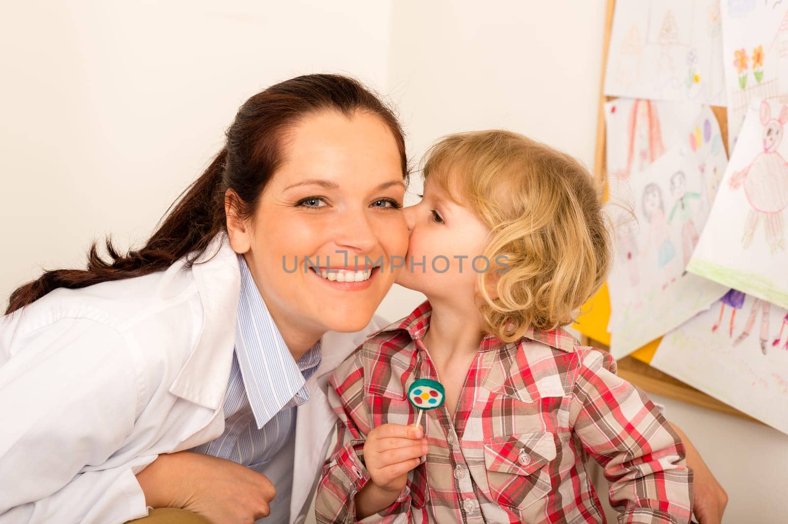 Thank you doctor - Little girl kissing female pediatrician