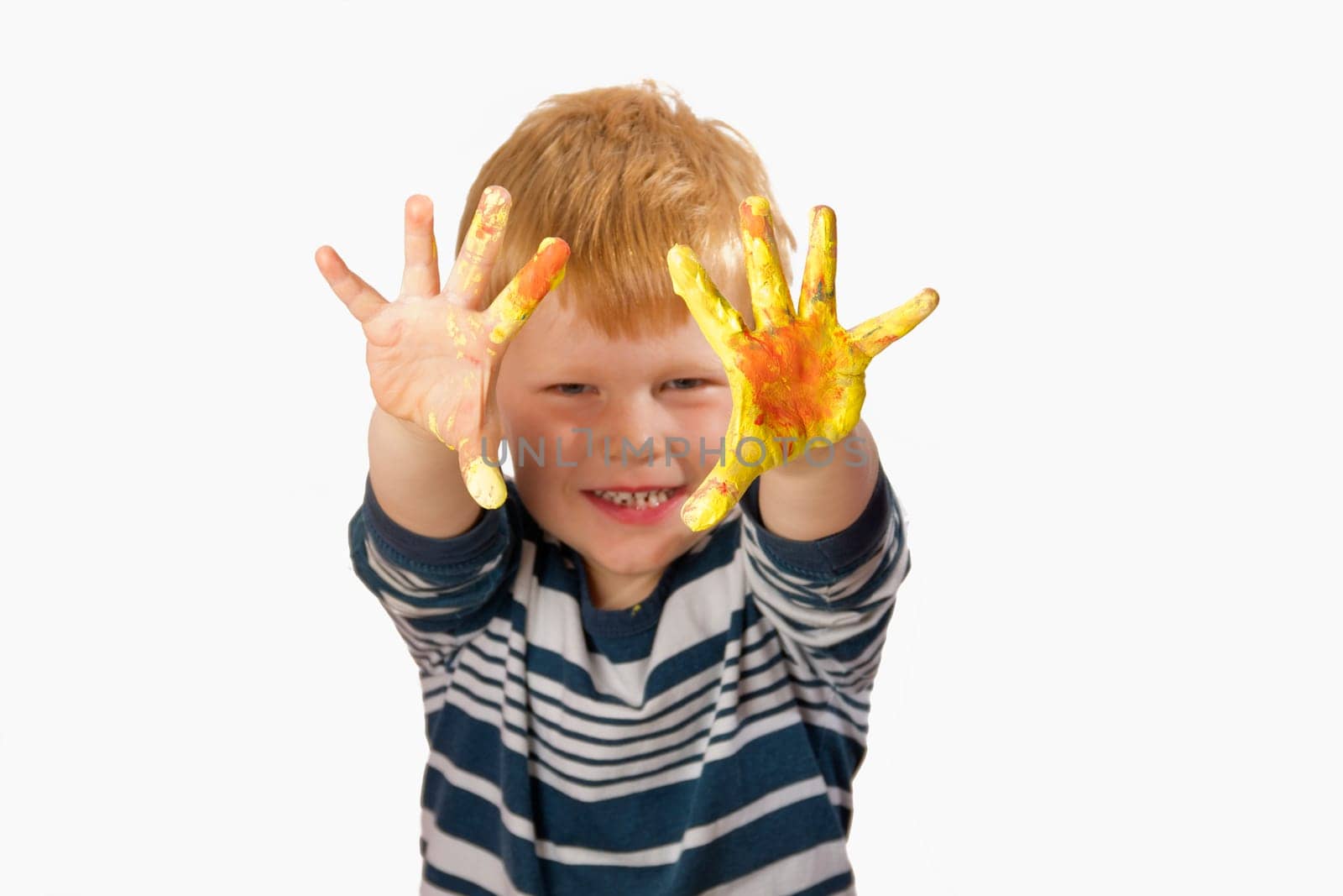 Boy paints with finger paints
