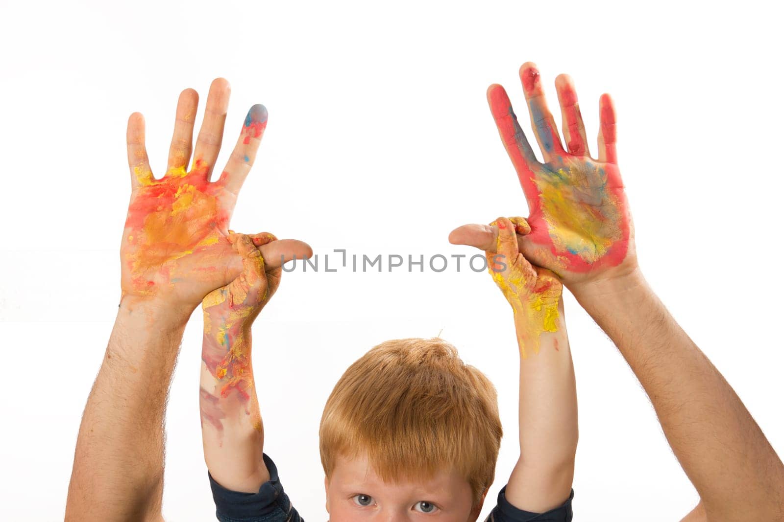 Boy holding his dad's painted hands