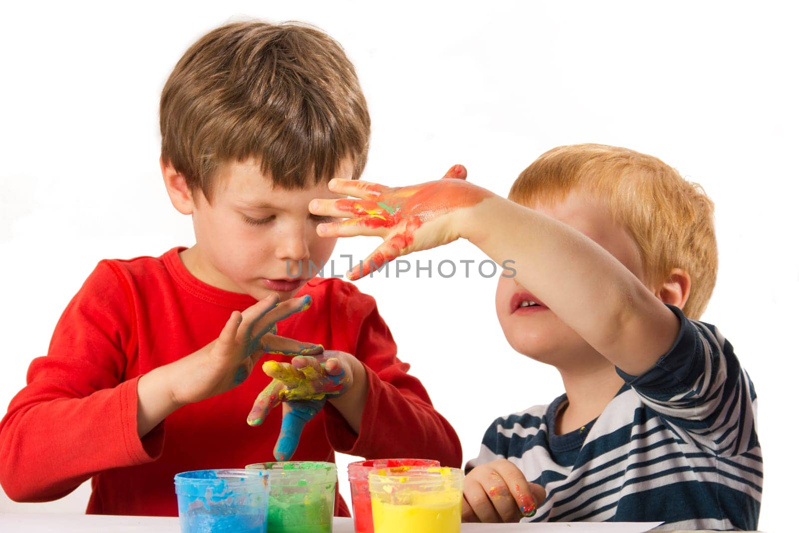 Children paint with finger paints and have fun doing it