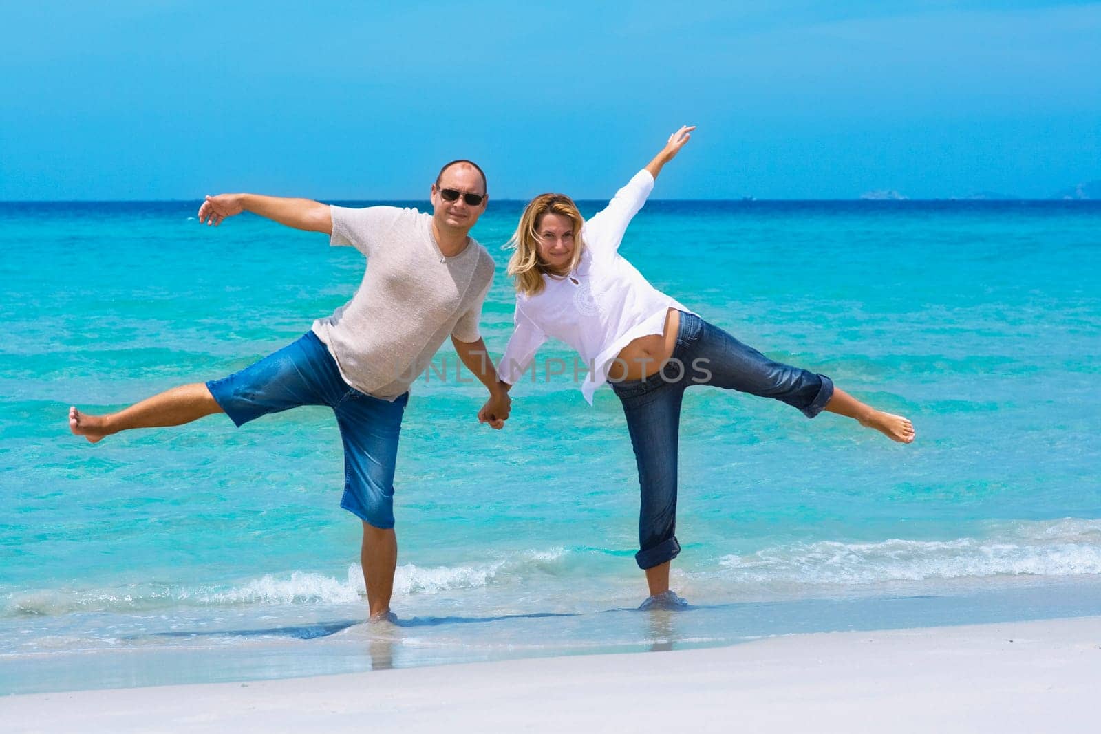 Young couple have a fun on the tropical beach