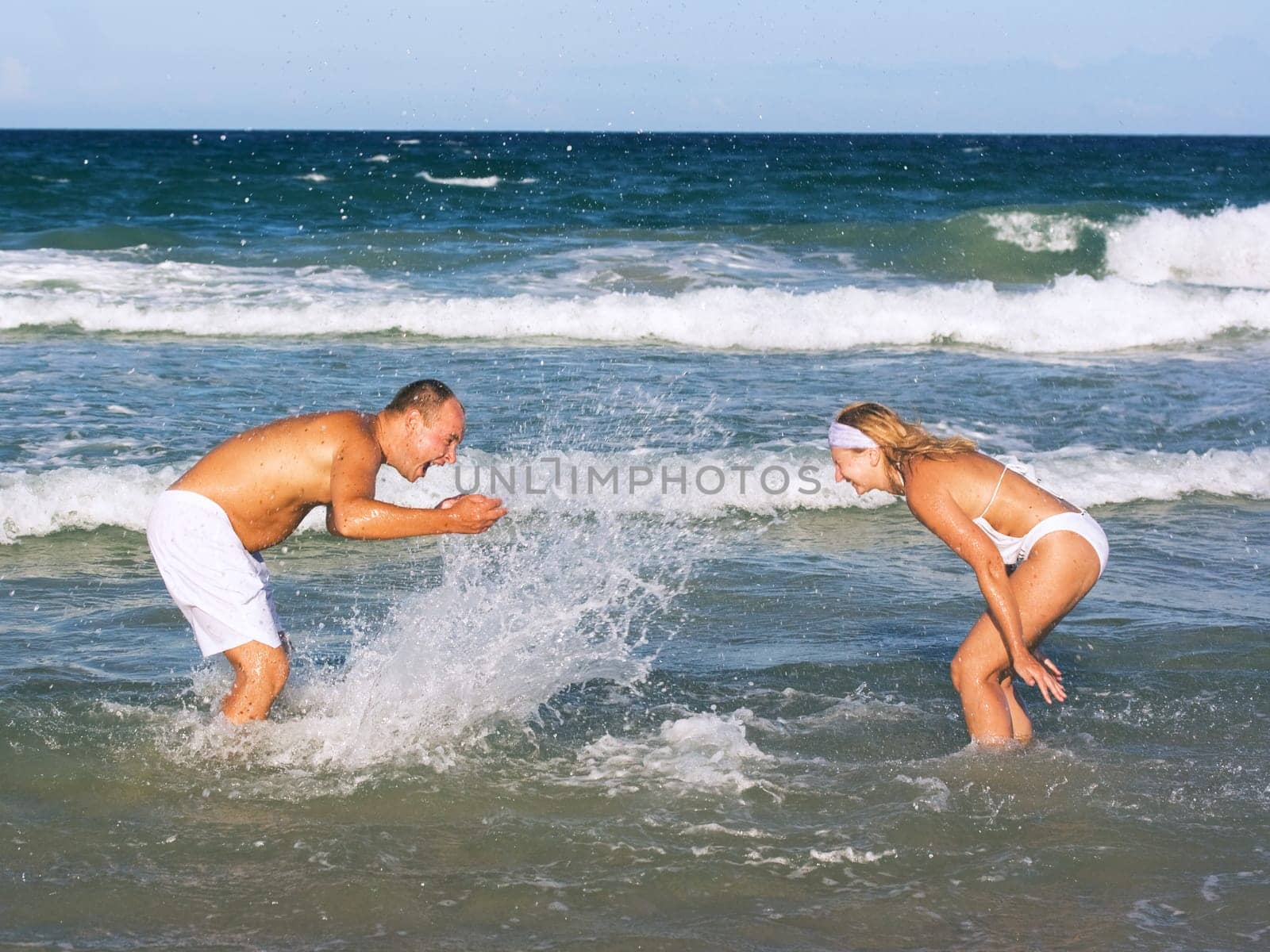 Young couple have a fun time on the tropical beach.