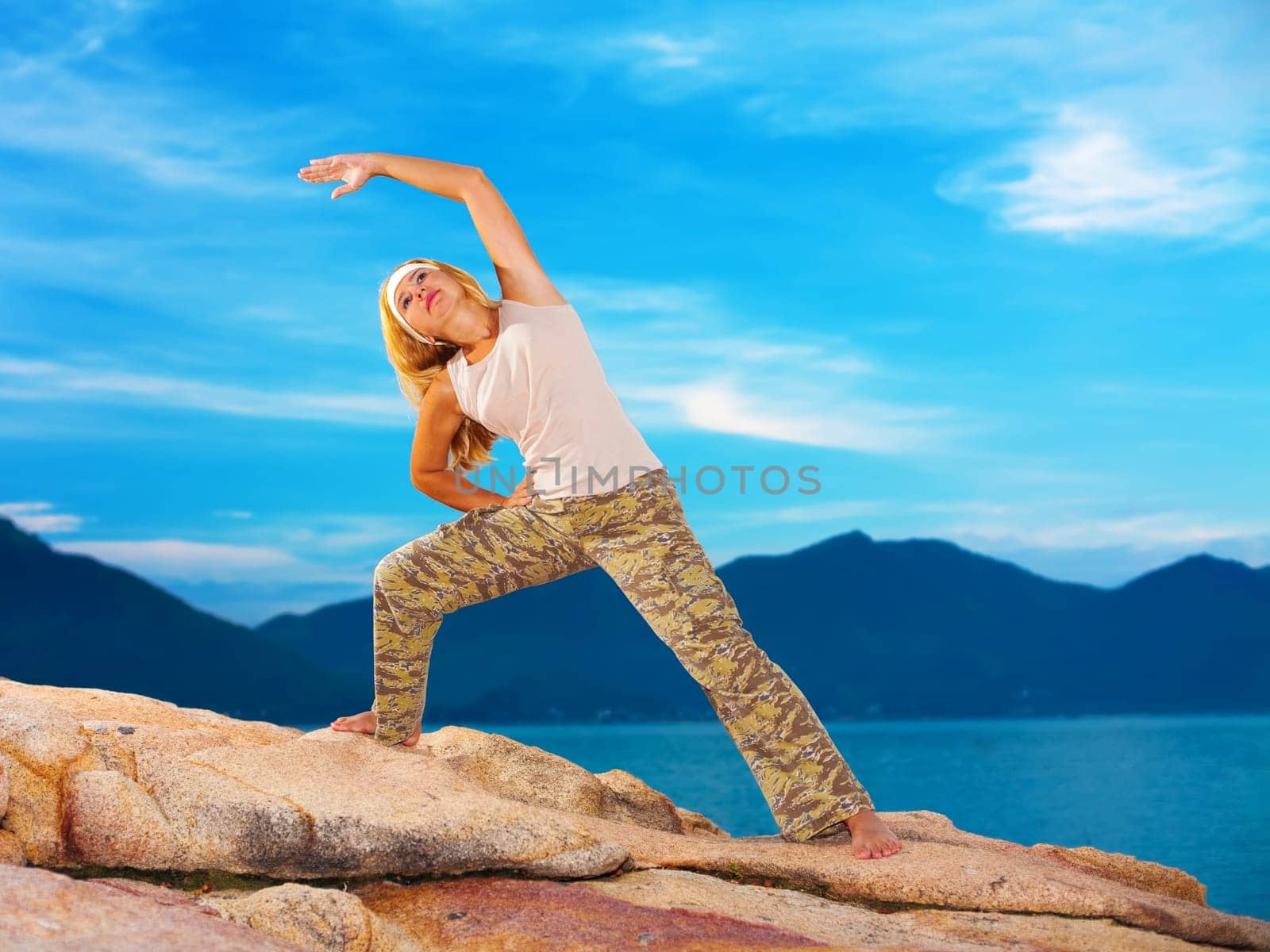 Young woman doing mornin exercises at sunrise time