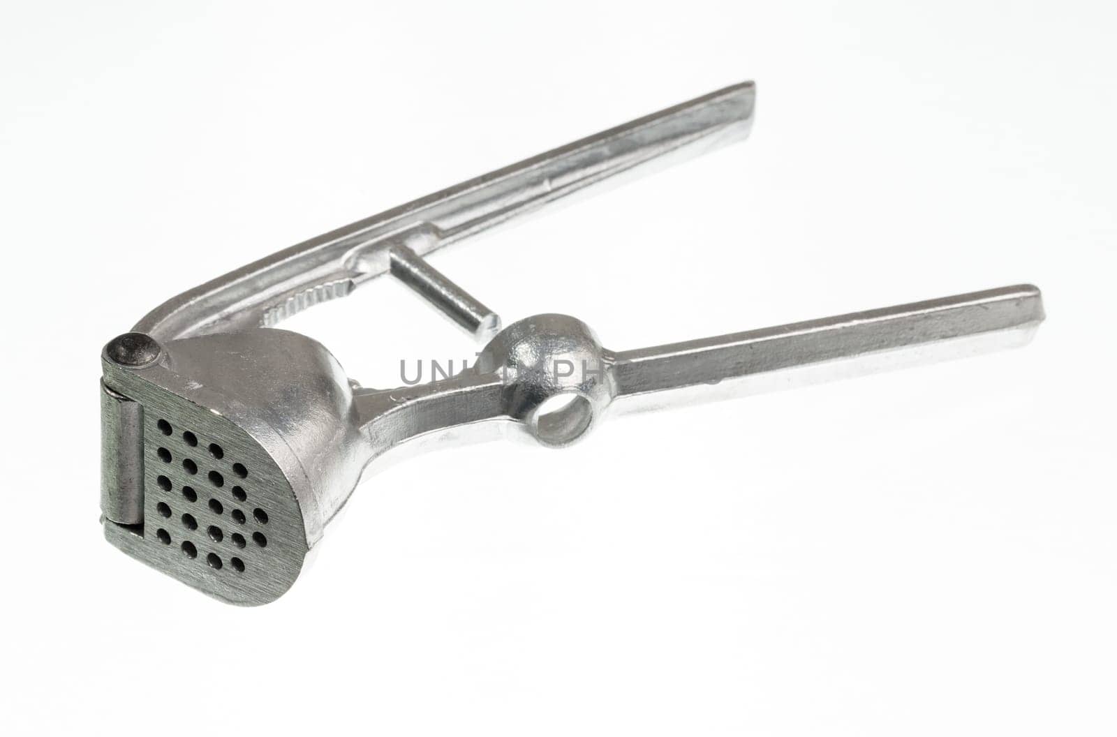 Garlic press isolated against white in macro shot