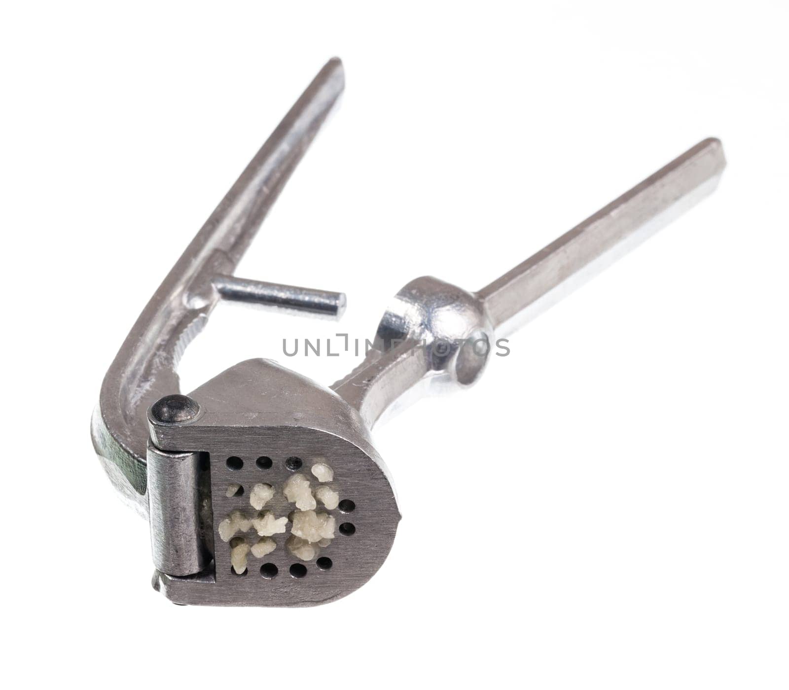 Garlic press and garlic isolated against white in macro shot