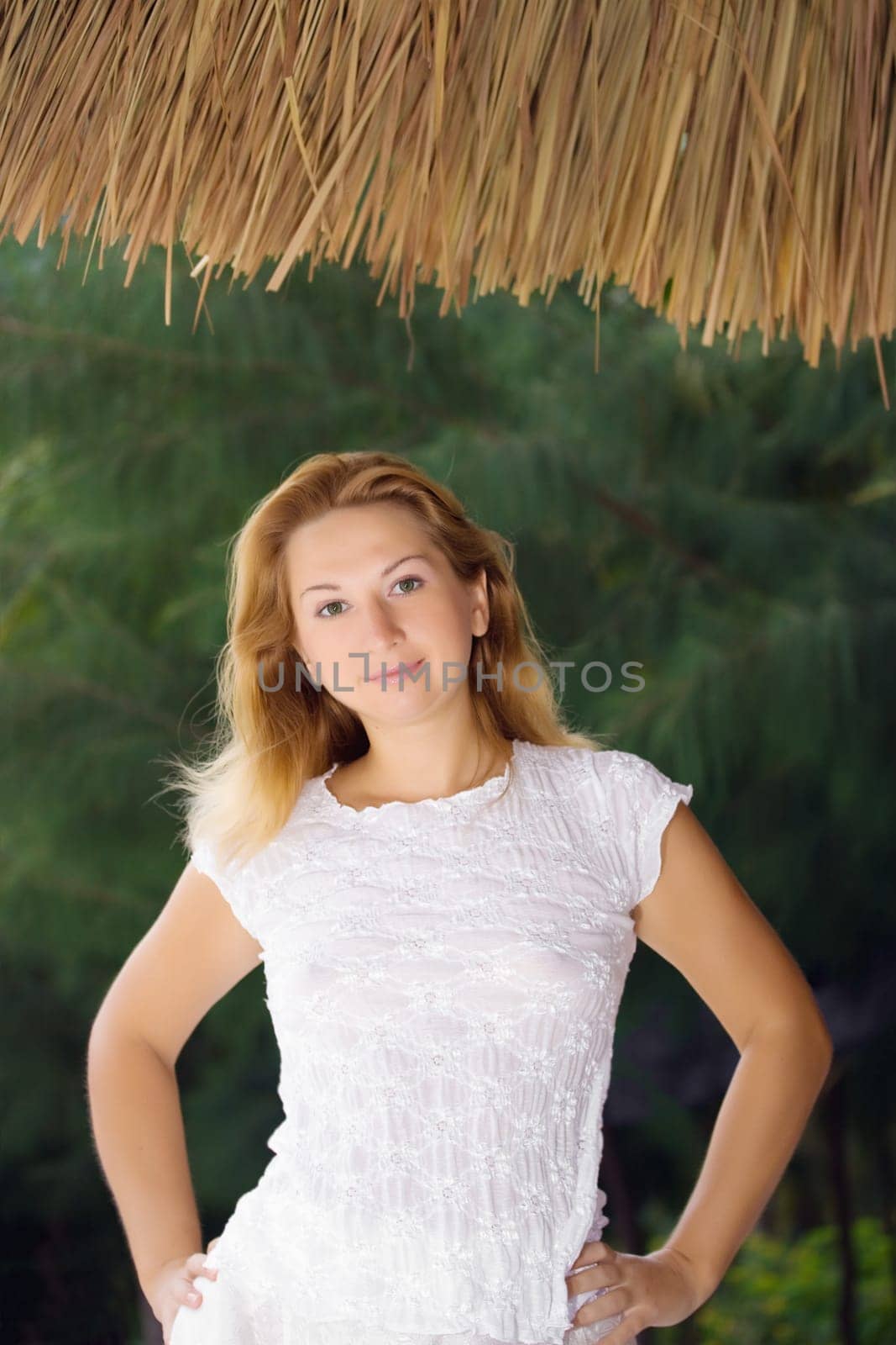 Young woman posing over natural green background