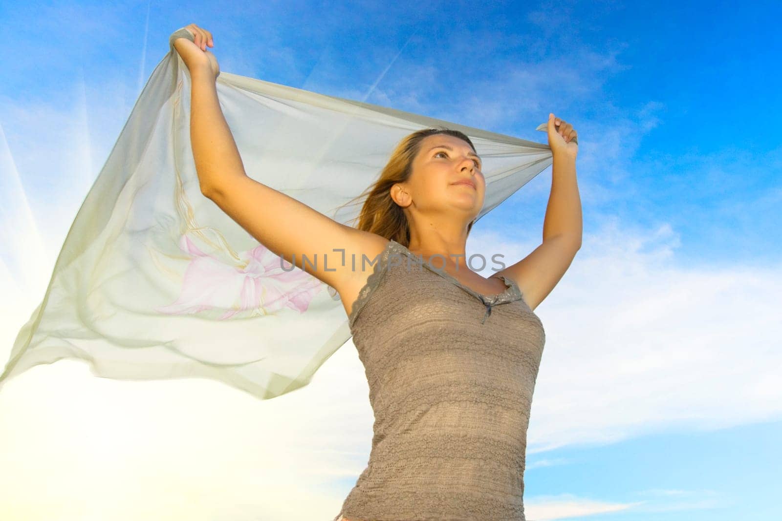 Woman on cloudy sky background and sunlight