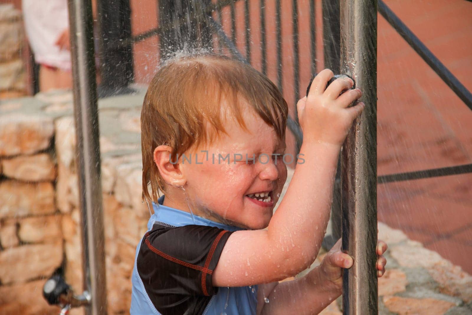 Boy taking a shower outside