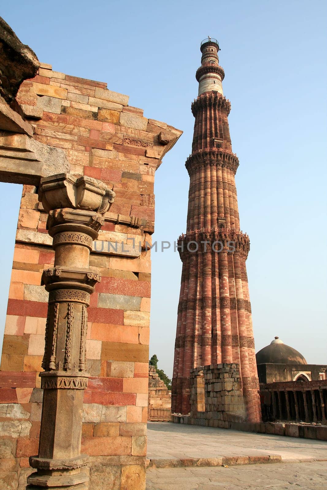 Qutub Minar with portion of surrounding structure in Delhi, India, Asia