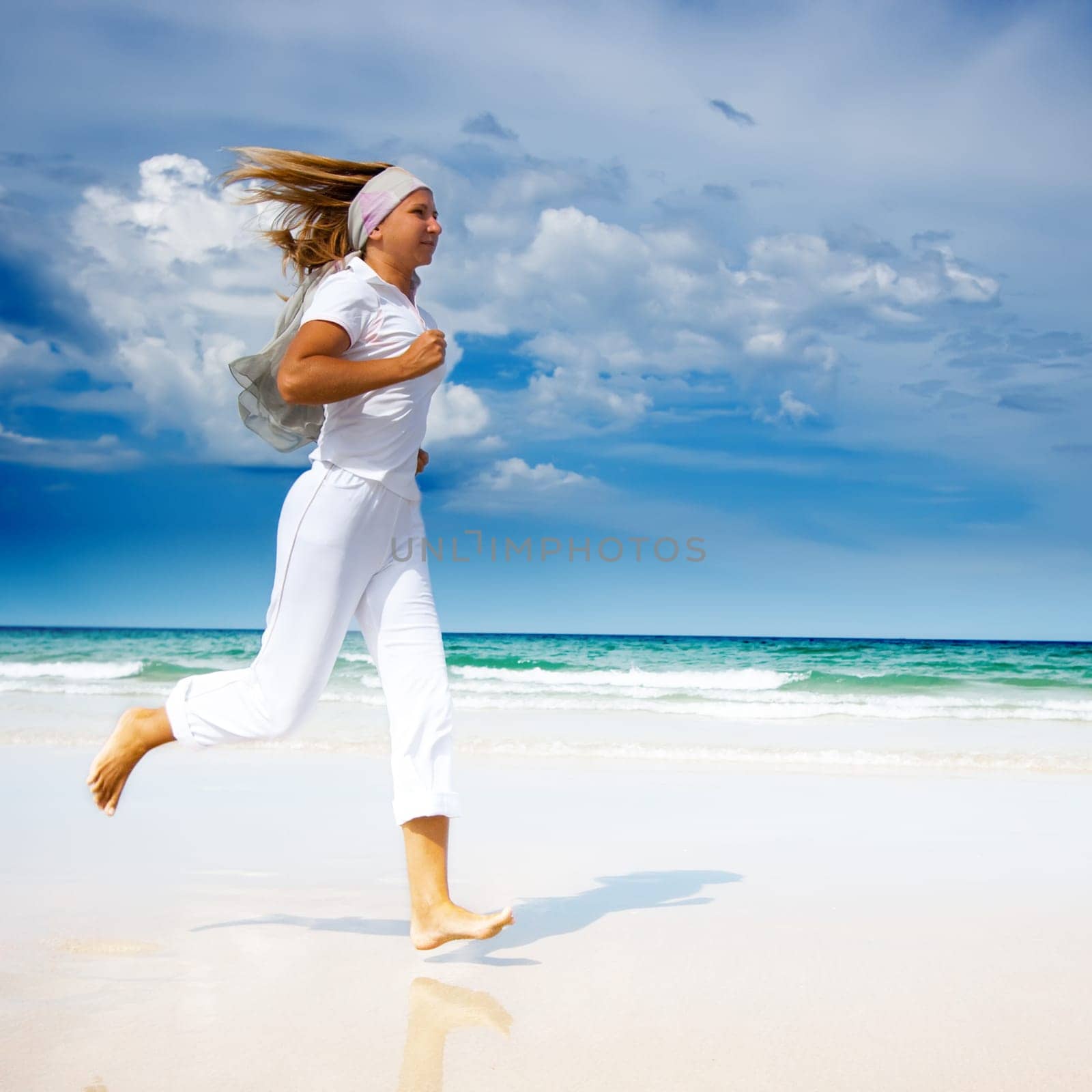 Young woman running on the beach