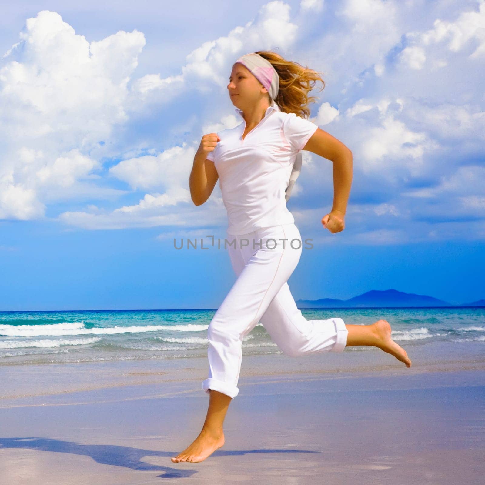 Young woman running on the beach