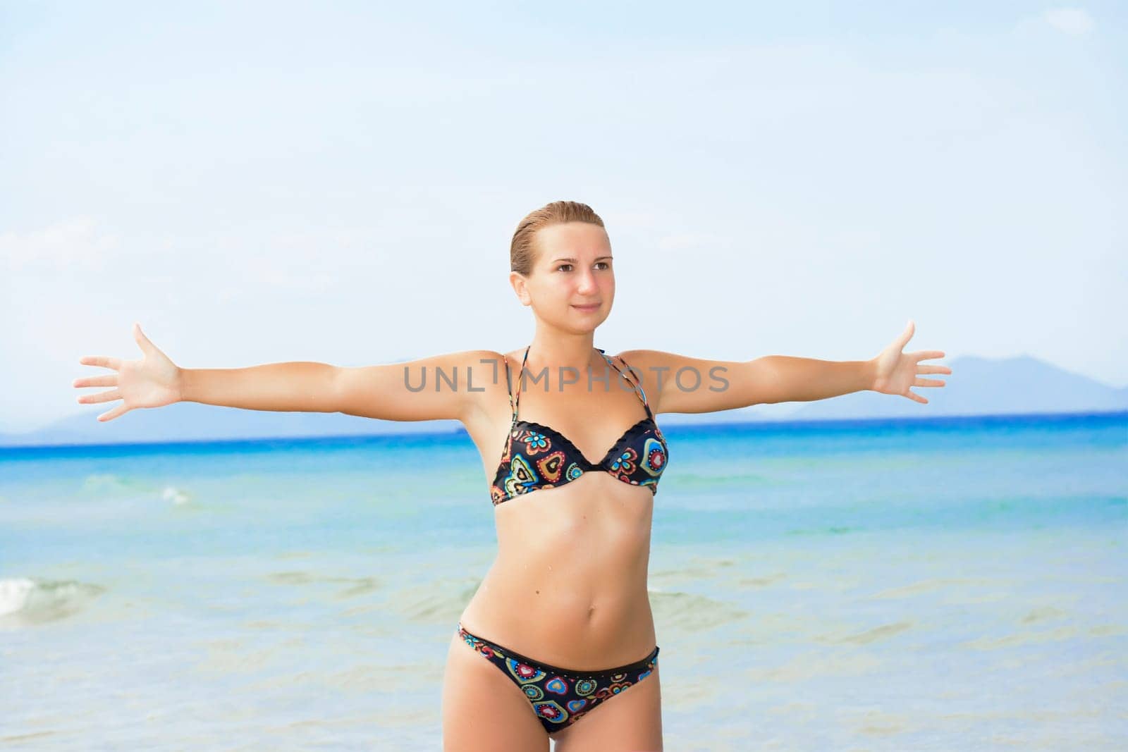 Young woman have a fan on the tropical beach