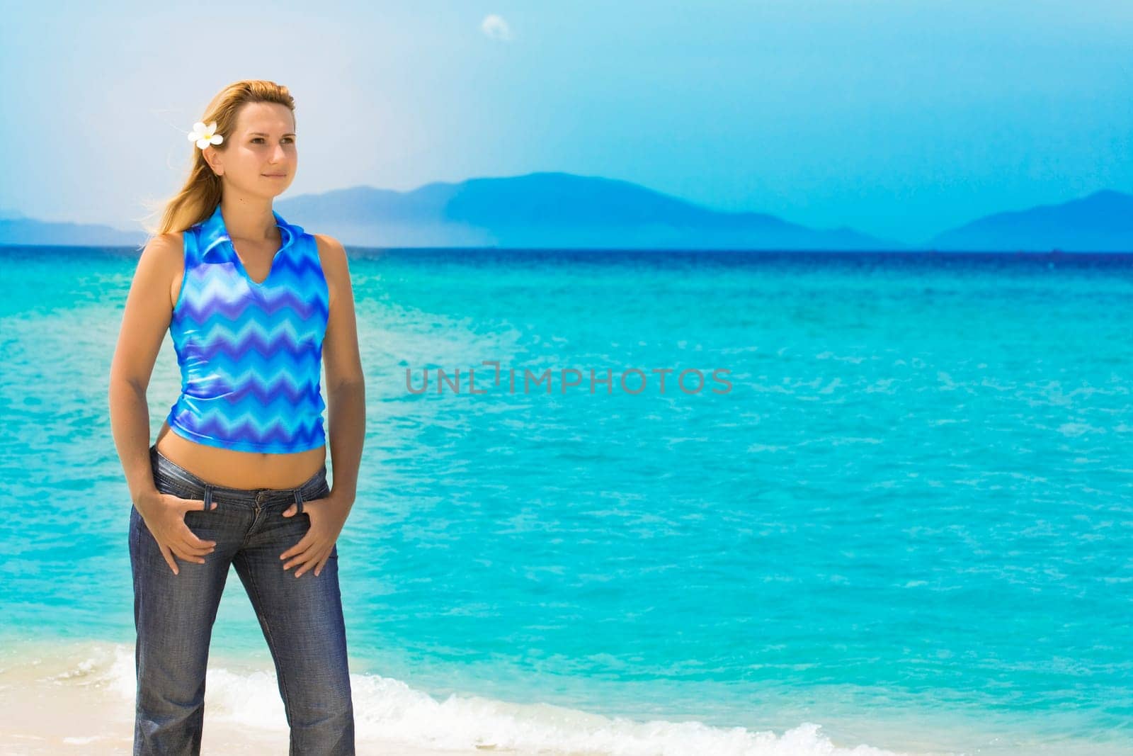 Beautiful young woman posing on the tropical beach