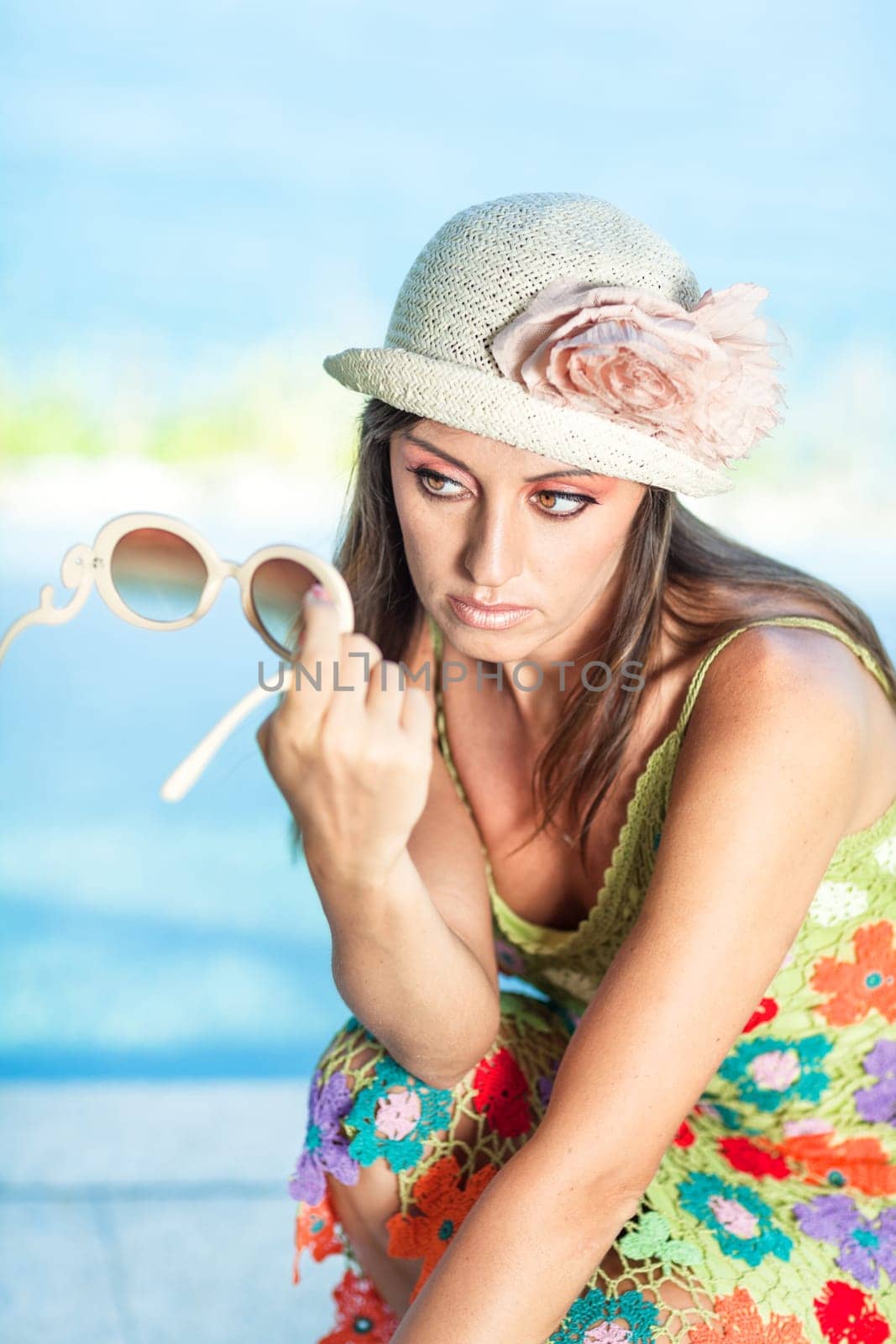 Beautiful woman in sunglasses and hat outdoor