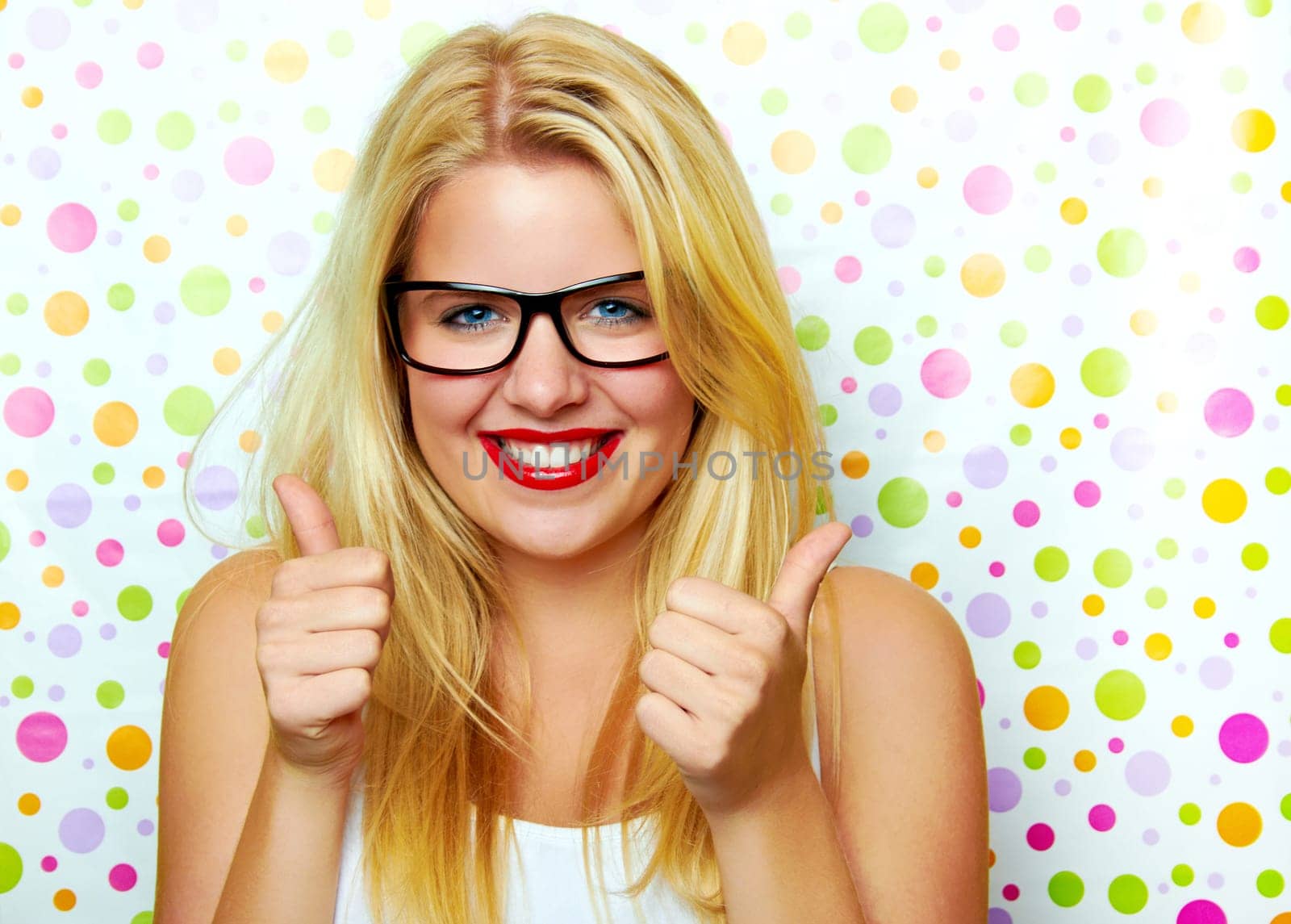Funny woman in glasses laughing with thumbs up