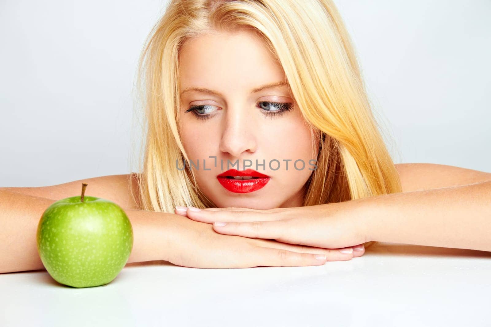 Young blonde woman with apple