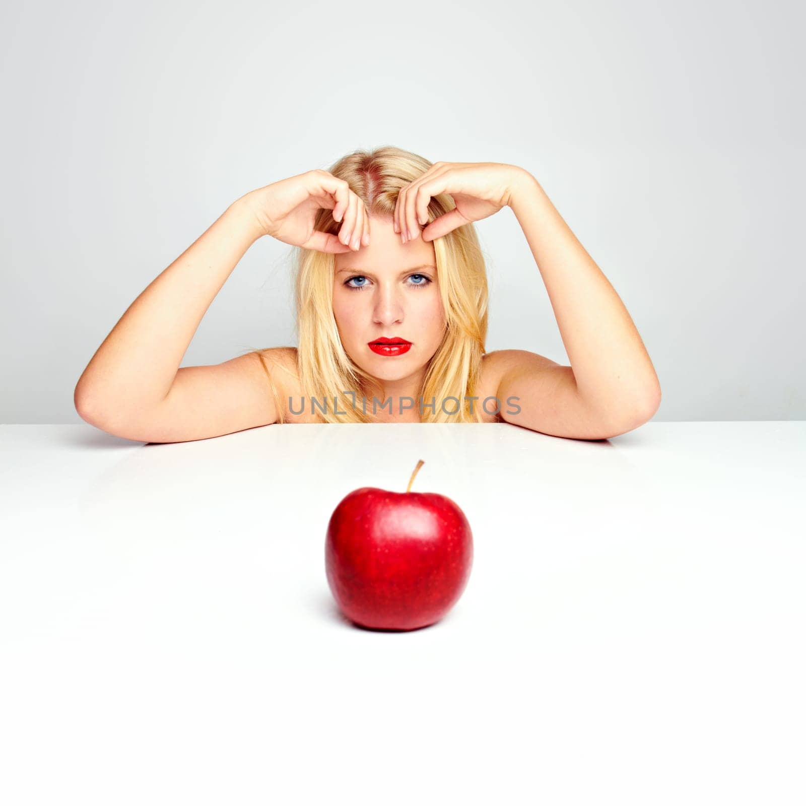 Young beautiful laughing girl with apple against white background