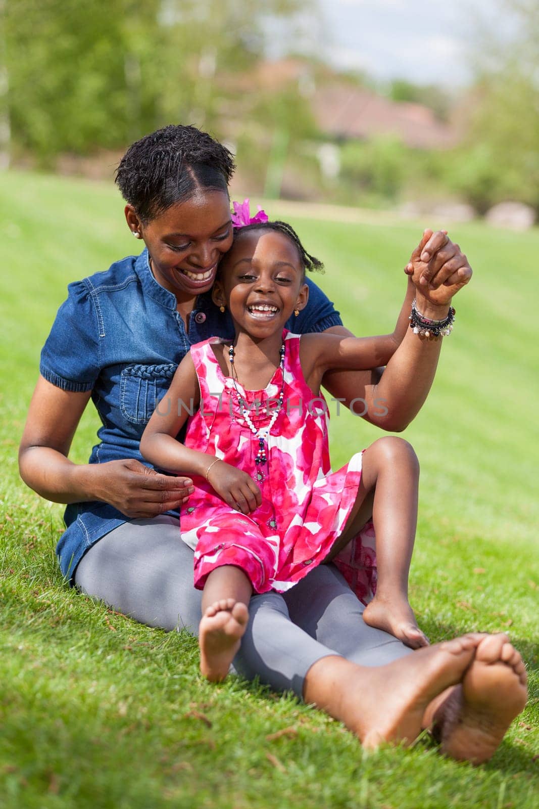 Portrait of a adorable african mother with her daughter in the garden