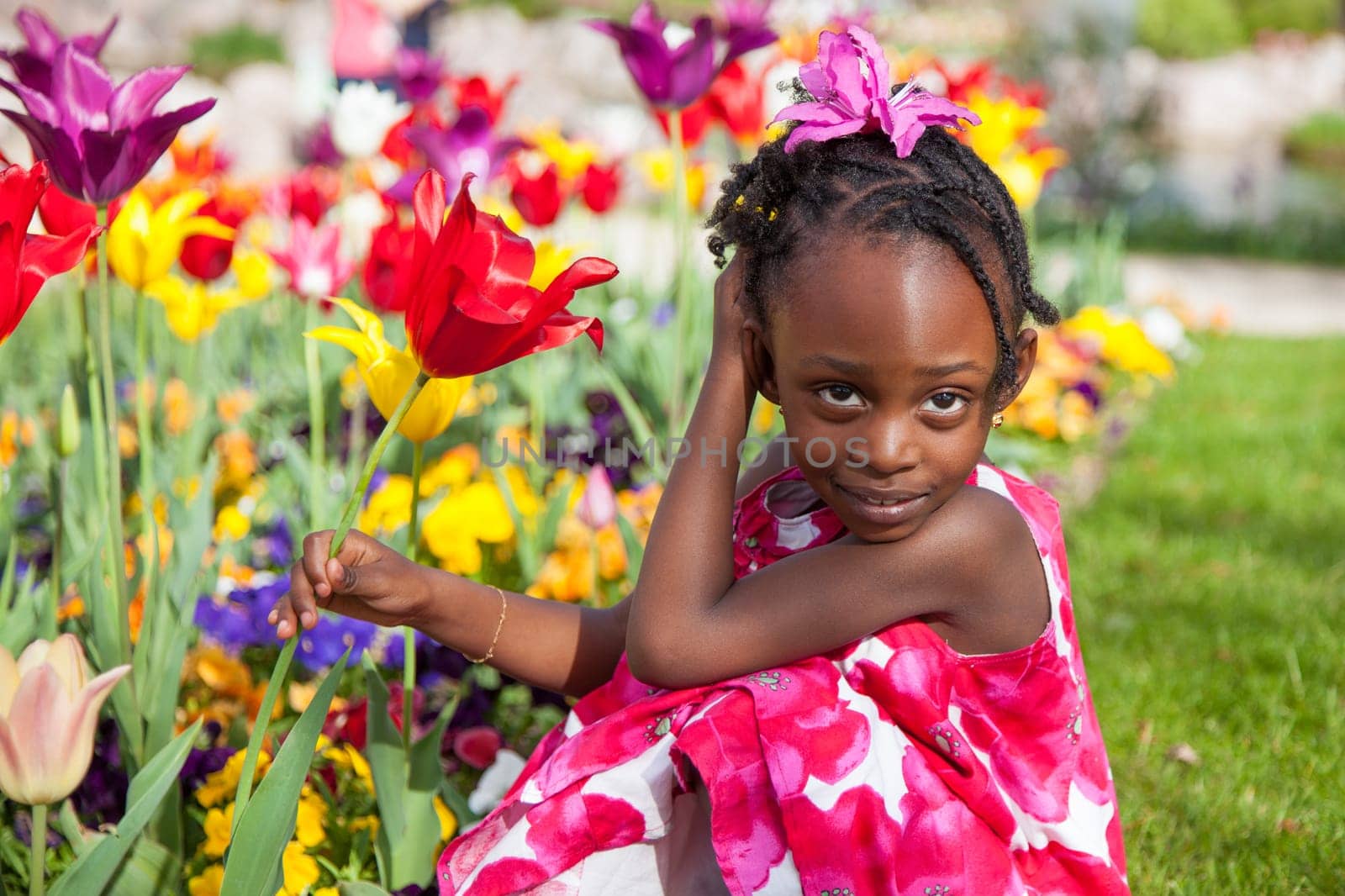 Portrait of a cute little african american girl playing in the garden