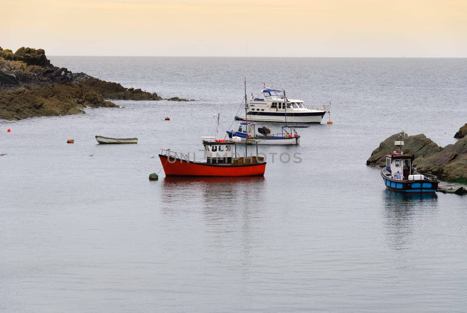 Boats on the sea in the Bay of Polperro in Cornwall