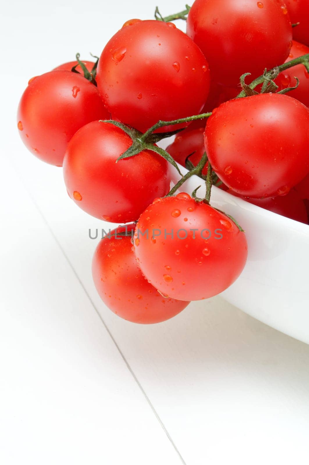 Closeup of Bunch of Fresh Cherry Tomatoes in White Bowl